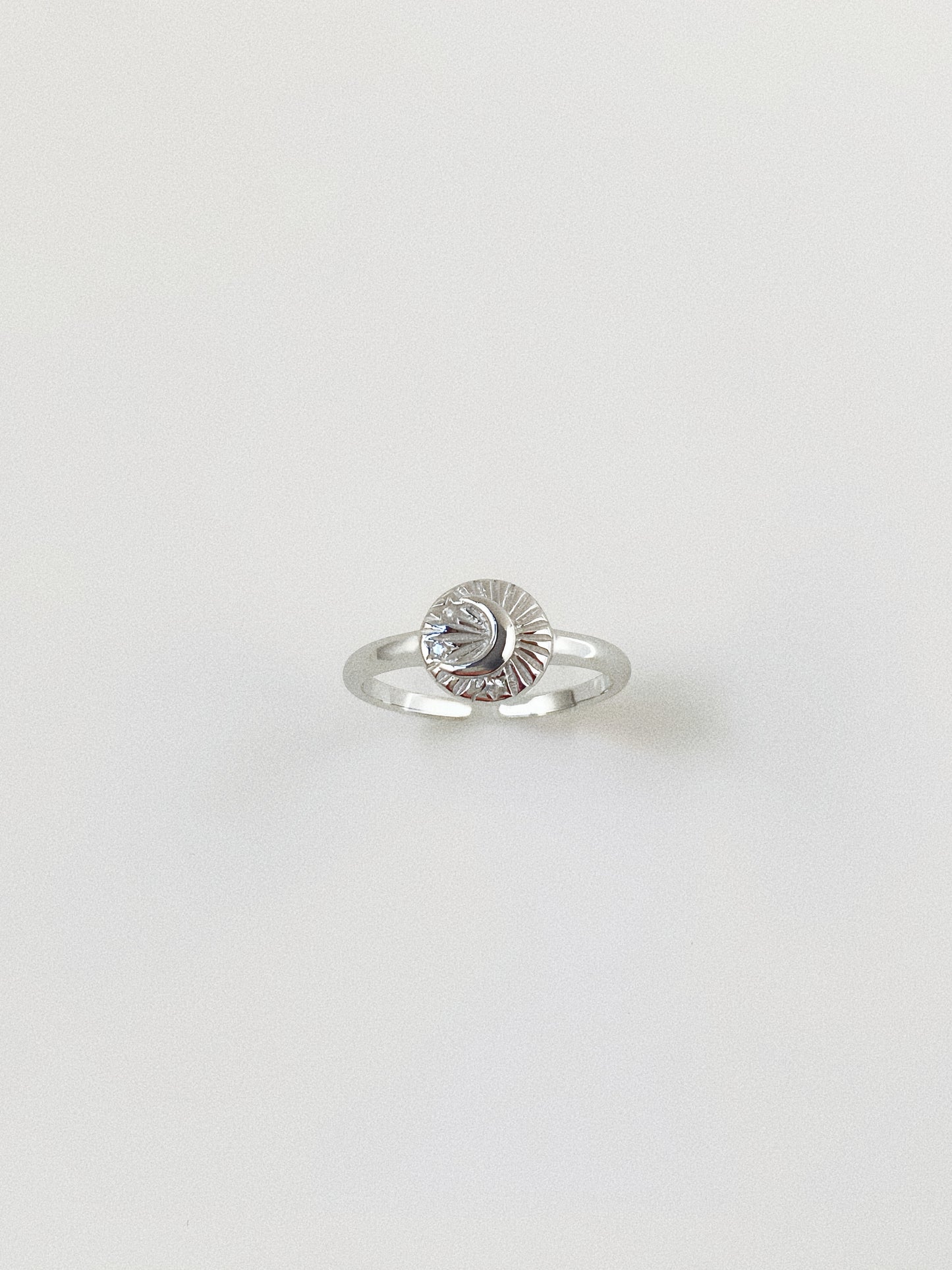 Close-up of the 925 sterling silver celestial ring showing the intricate engraved details.