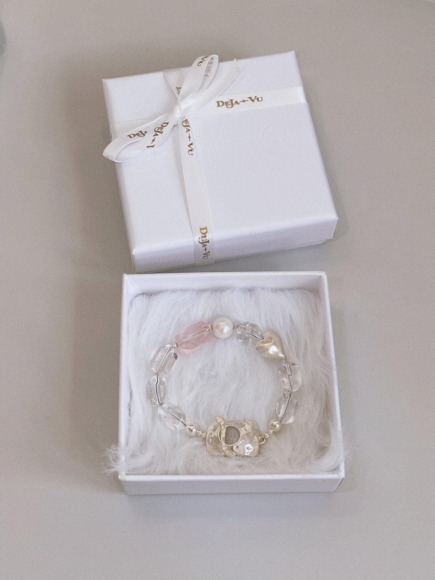 Handmade clear quartz and pearl bracelet presented in a Deja Vu Jewellery white gift box with logo ribbon