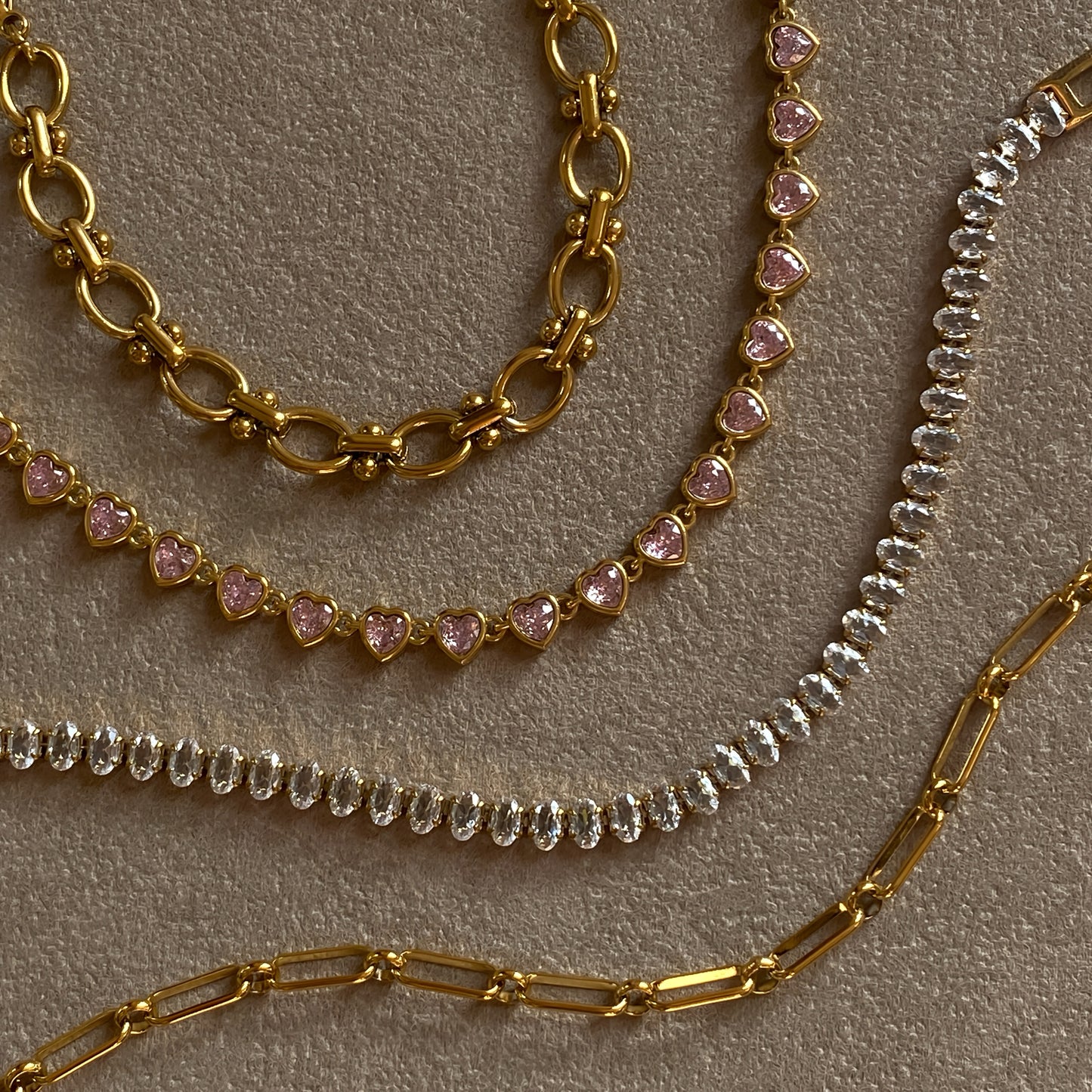 Gold paperclip chain bracelet stacked with tennis and heart bangles, waterproof stainless steel, hypoallergenic