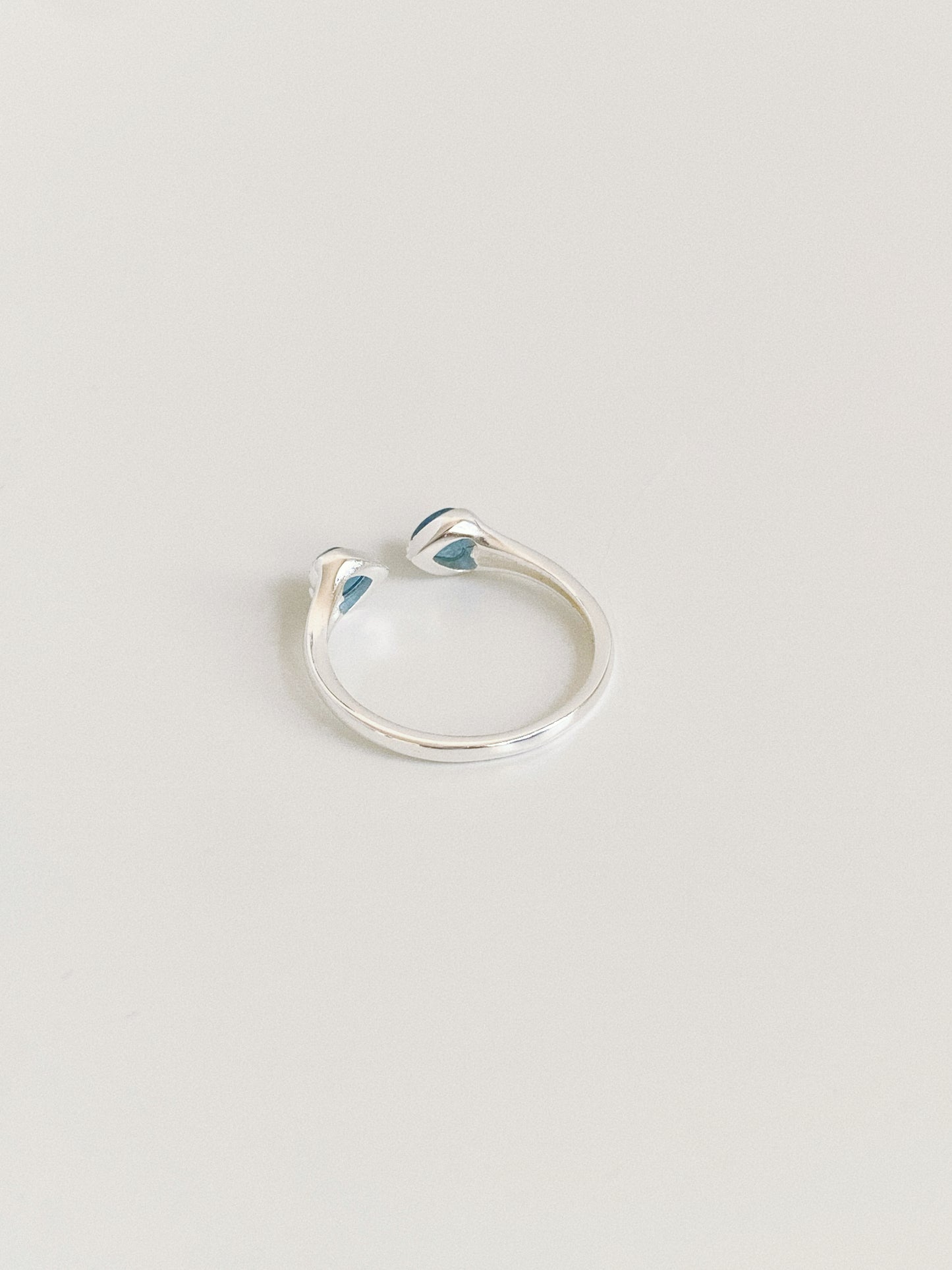 Back view of the adjustable open band sterling silver ring showing the flexible gap construction