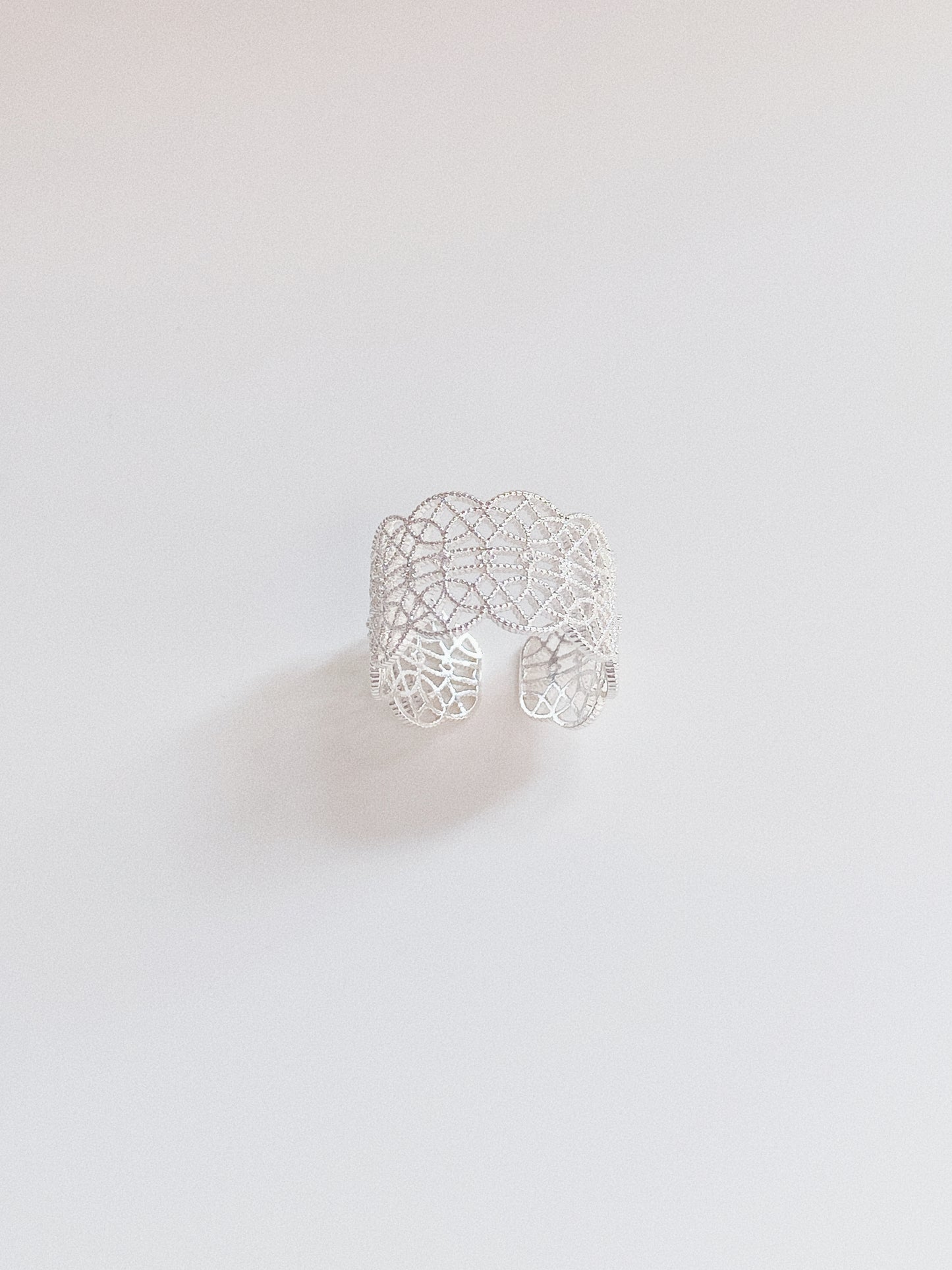The sterling silver version of the lace ring, highlighting its delicate openwork and adjustable band.