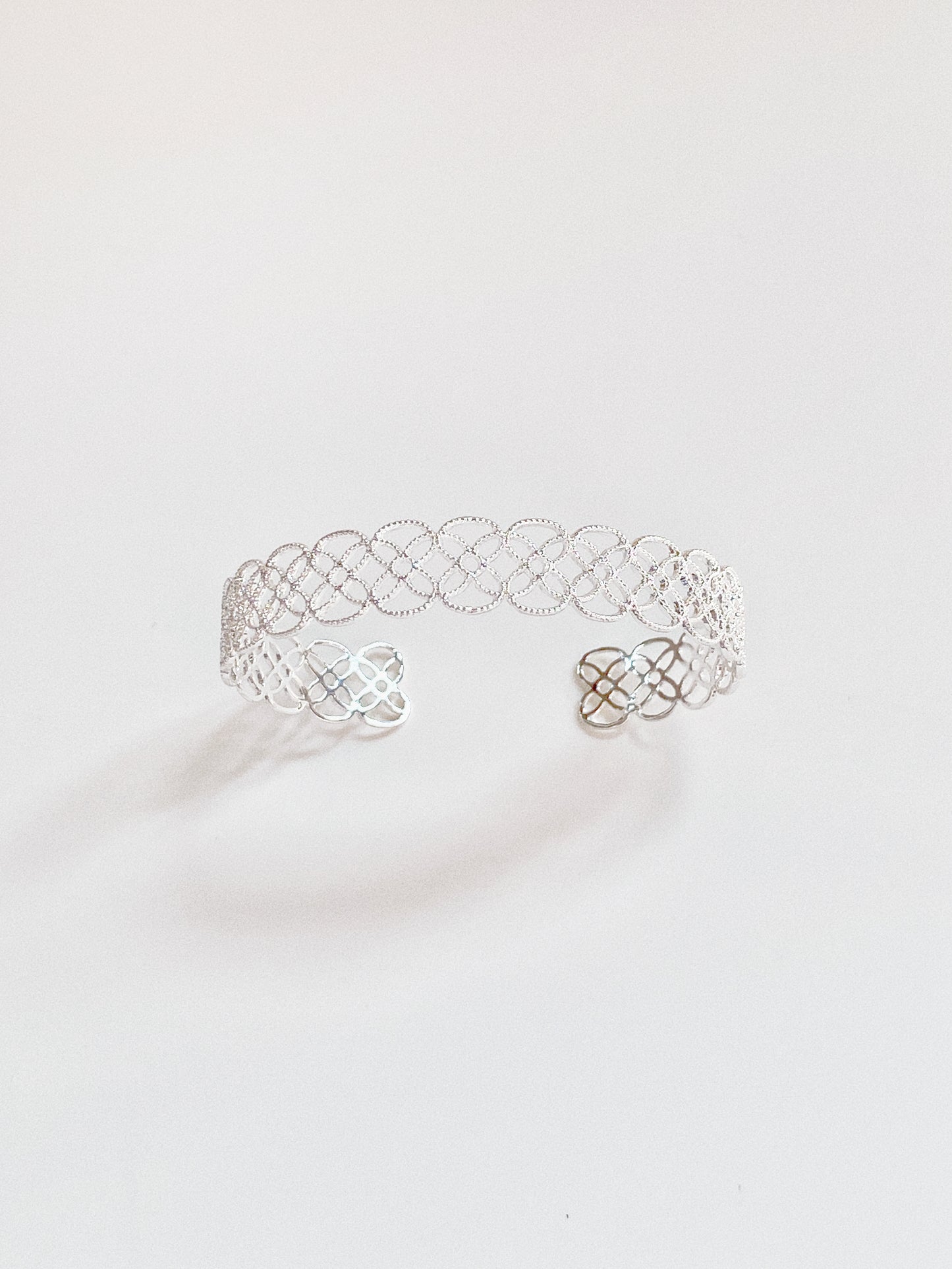 The sterling silver version of the Arabesque Petal Lace Cuff, highlighting its crisp, modern shine.