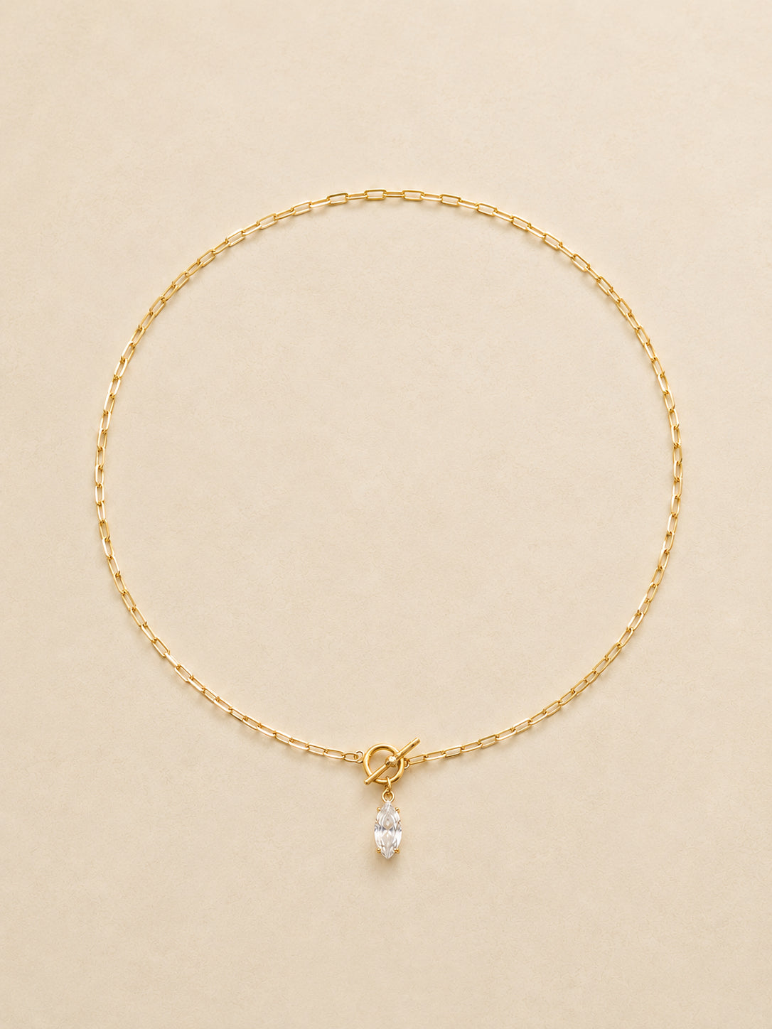 Full length flat lay of a 46cm gold toggle necklace with a marquise drop sitting at the front, waterproof tarnish-free chain