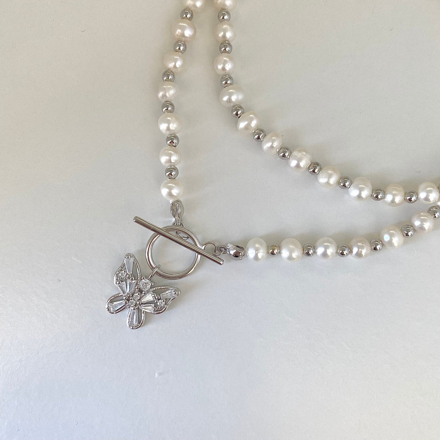 Elegant Pearl Cascade S925 Silver Butterfly Necklace