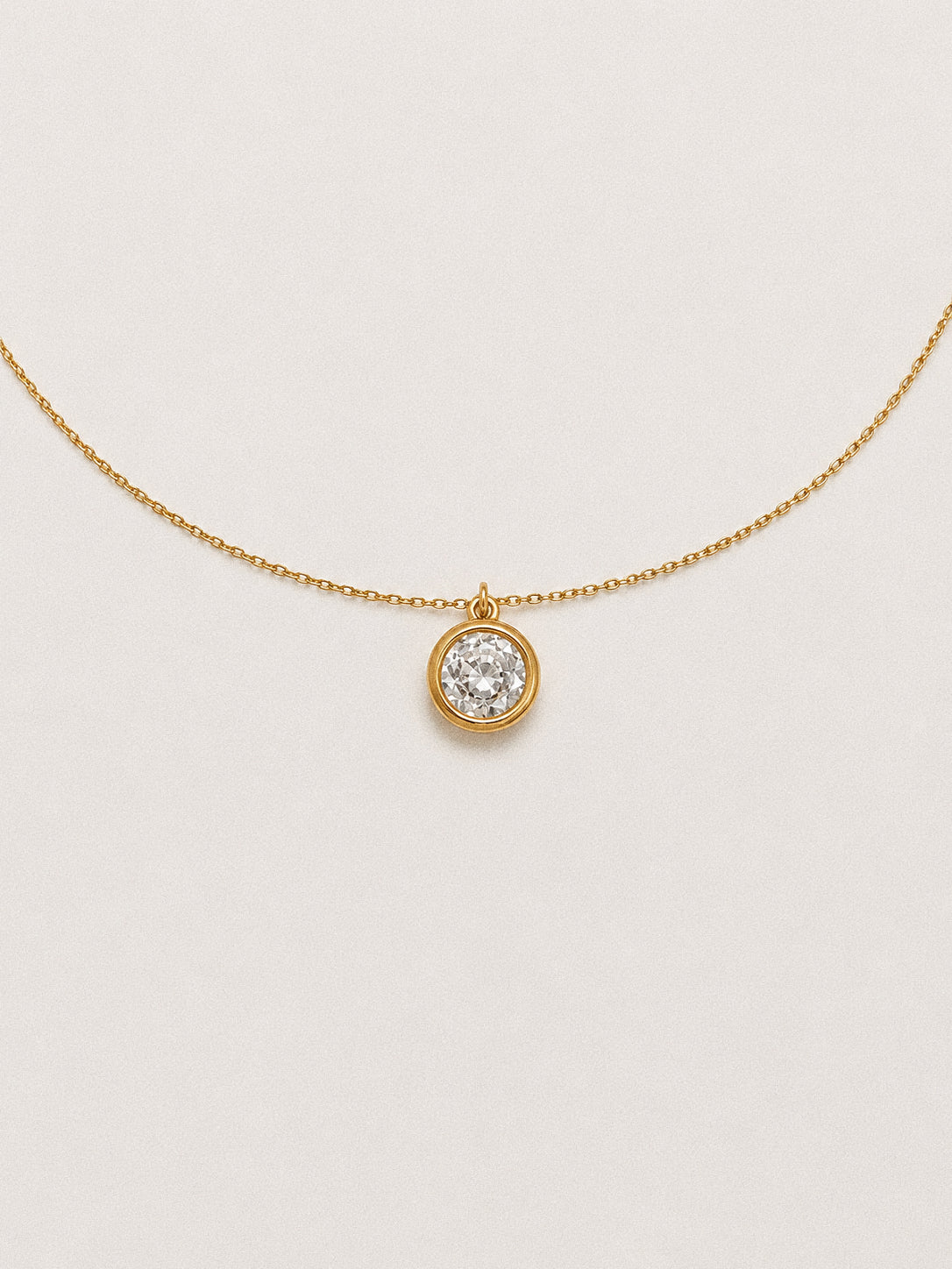 Front view of the 2 carat solitaire necklace with the bezel pendant centred on a fine gold chain