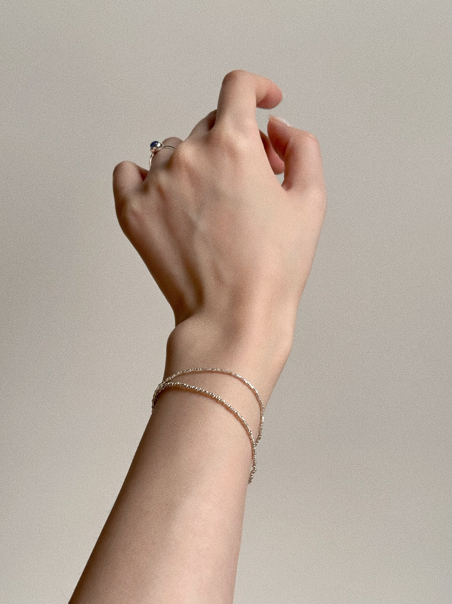 Minimalist view of the 925 sterling silver faceted chains, showing the delicate double-strand structure sitting elegantly on the wrist.