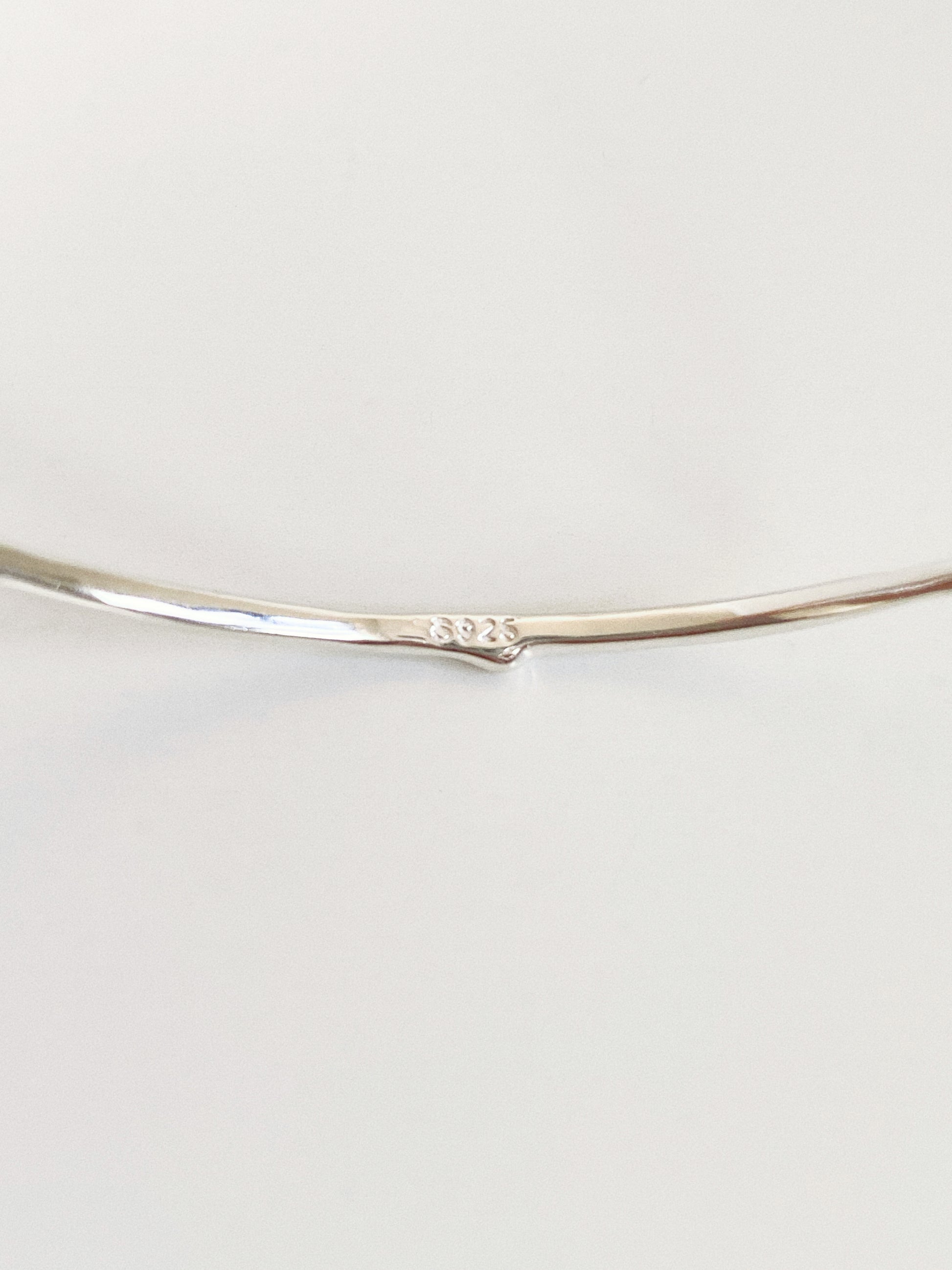 Close up of the S925 hallmark stamped on the sterling silver band of the Rivage cuff bangle