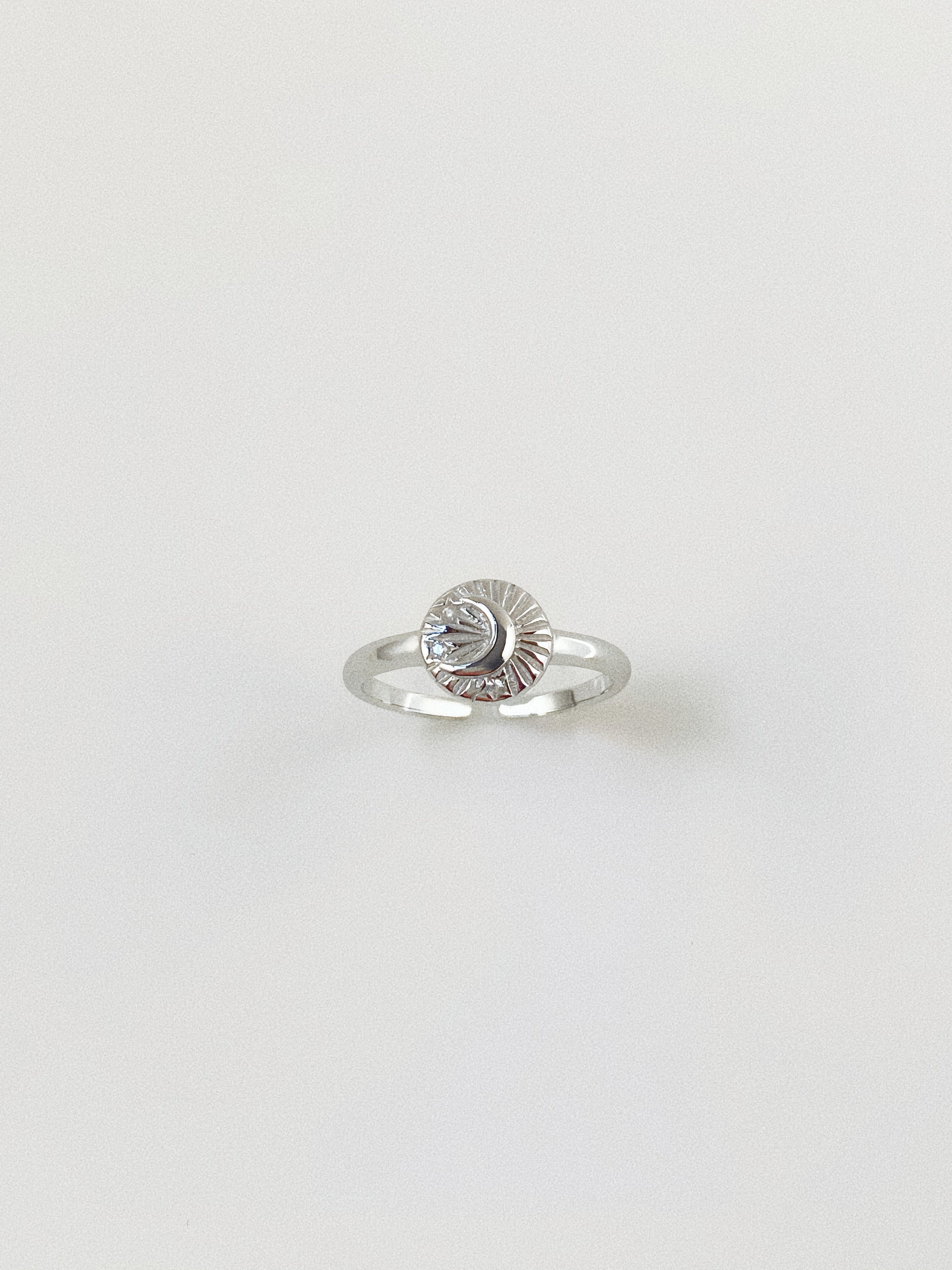 Close-up of the 925 sterling silver celestial ring showing the intricate engraved details.