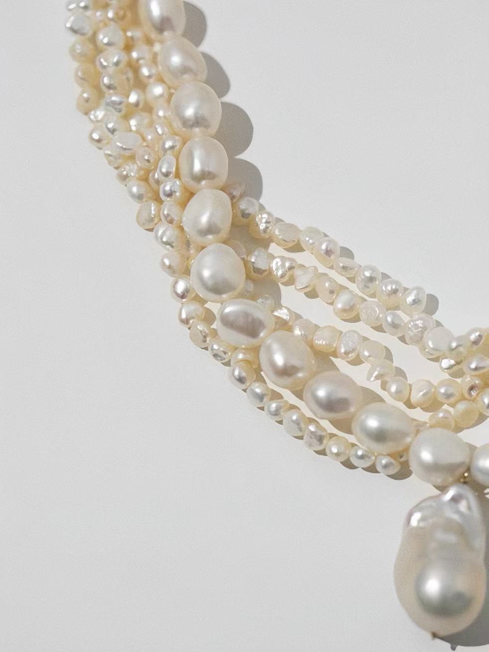 Side view of genuine freshwater pearls showing high luster and organic irregular baroque shapes.