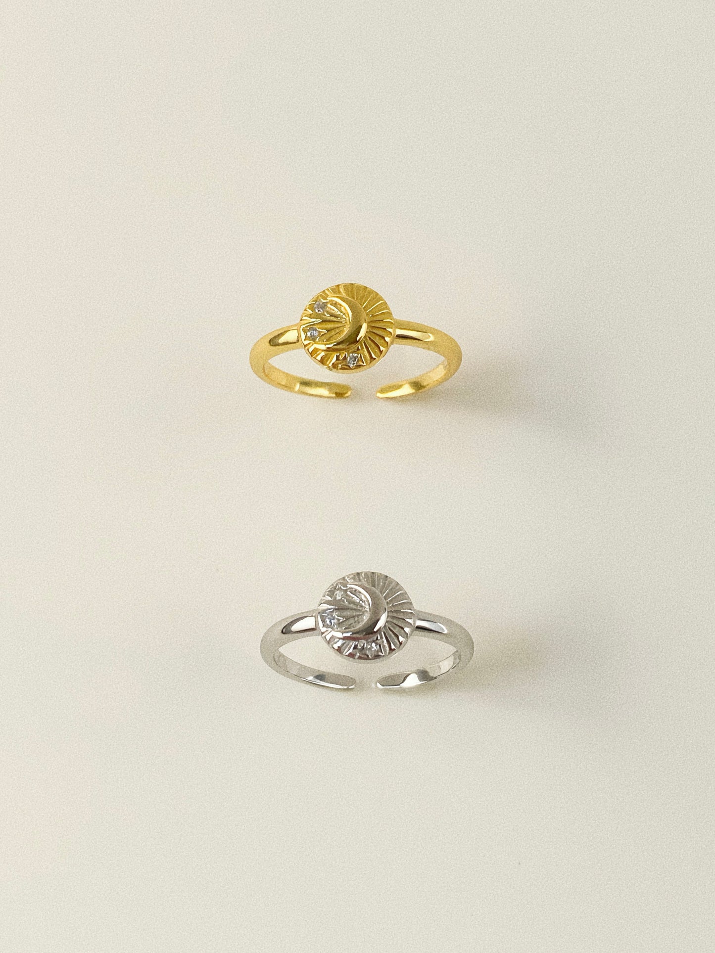 Top view of gold and silver celestial signet rings featuring crescent moon and star motifs.