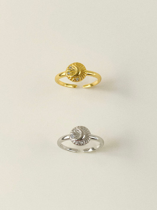 Top view of gold and silver celestial signet rings featuring crescent moon and star motifs.