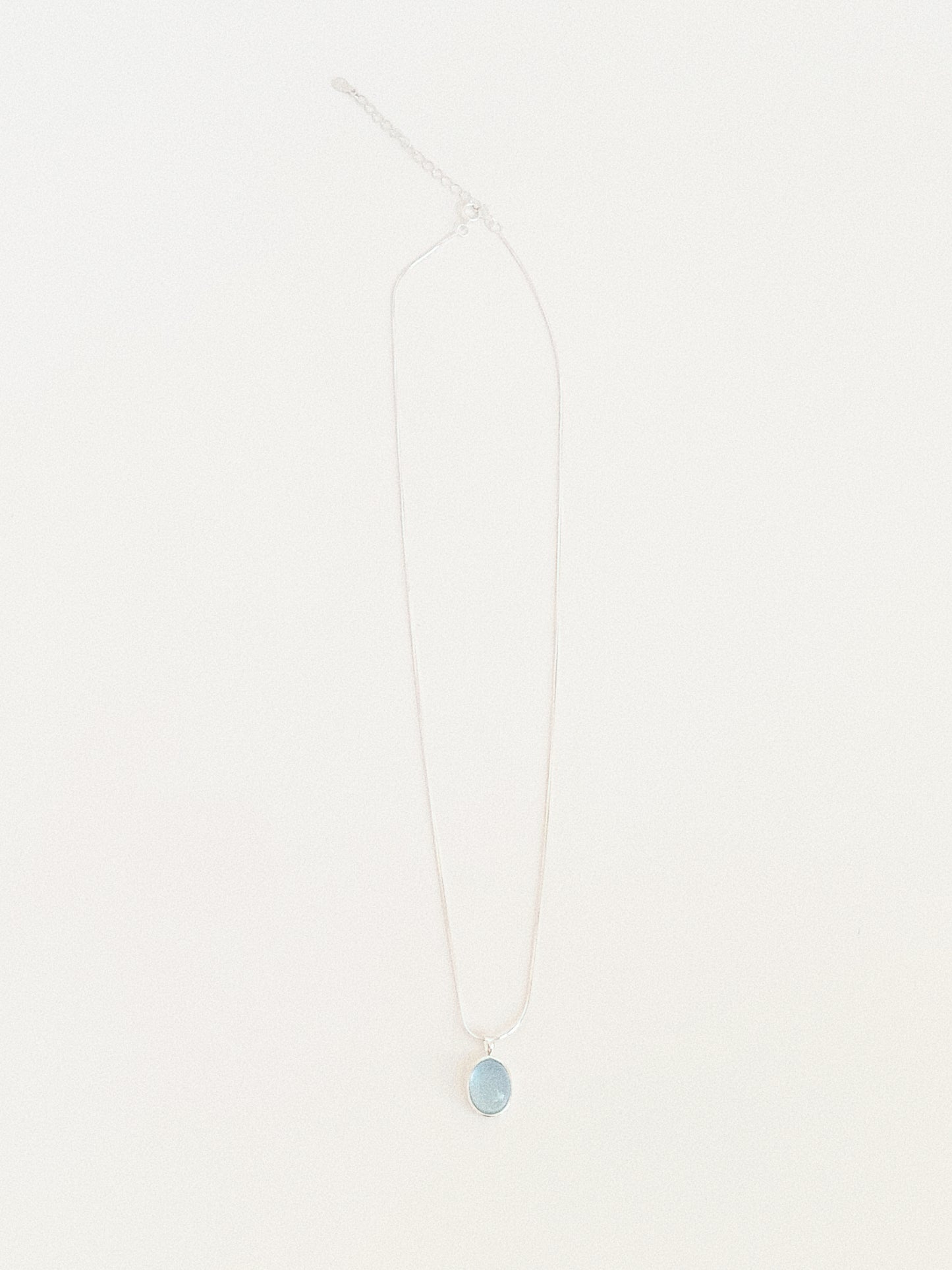 Full length flat lay of the aquamarine pendant necklace showing the 39.5cm snake chain with 5cm extender and clasp