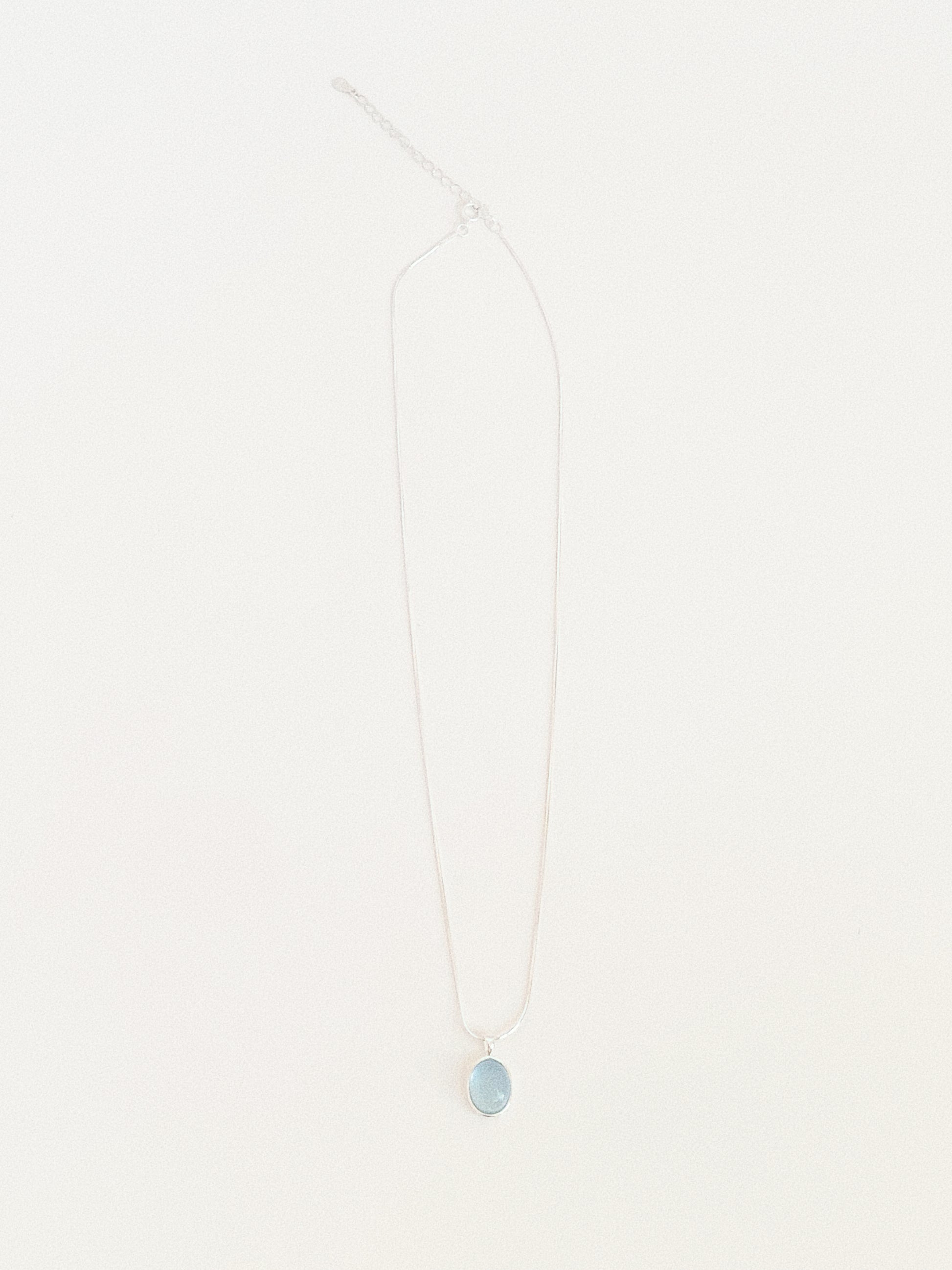 Full length flat lay of the aquamarine pendant necklace showing the 39.5cm snake chain with 5cm extender and clasp
