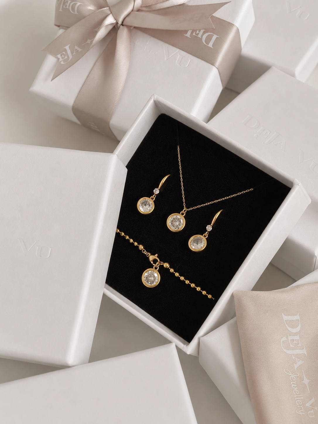 Aura drop earrings in a Deja Vu Jewellery gift box with the matching necklace and bracelet from the collection