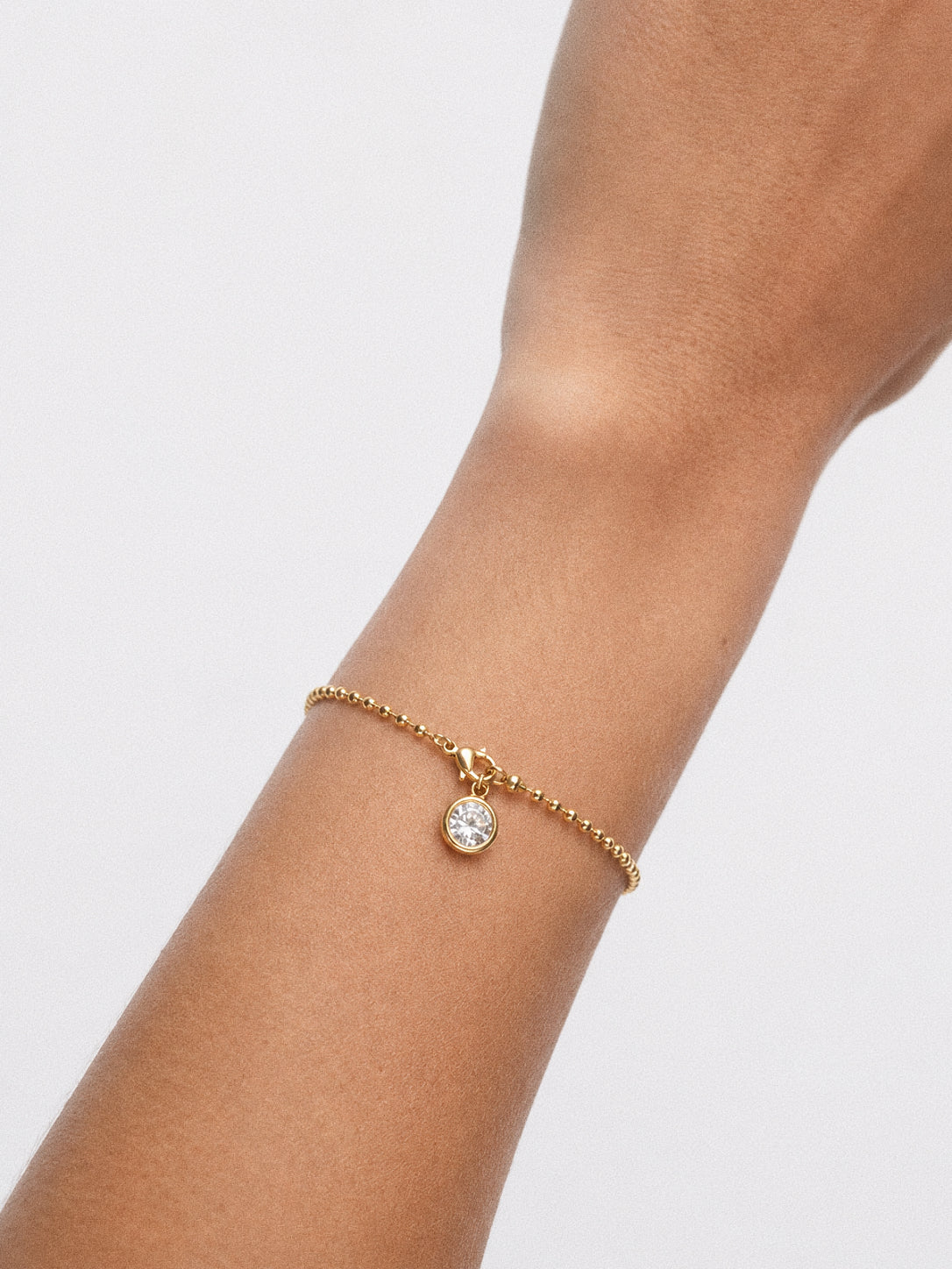 Model wearing the ball chain bracelet from the Aura jewellery set on her wrist