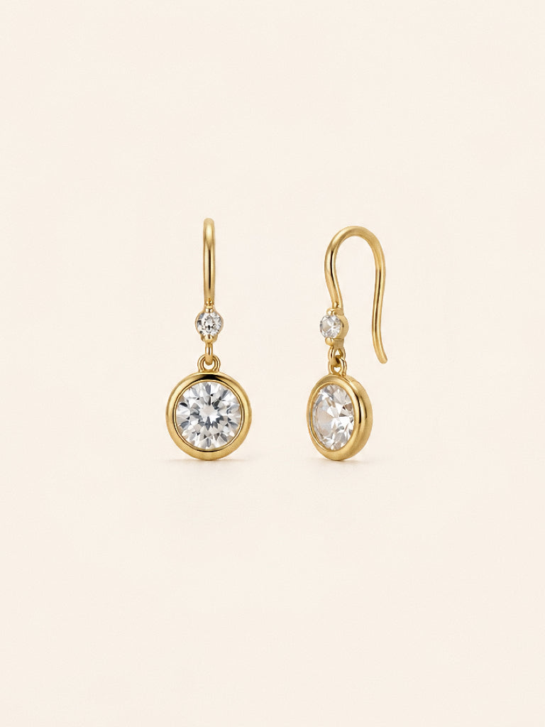 The drop earrings from the Aura jewellery set with bezel set stones and small accents on gold hooks