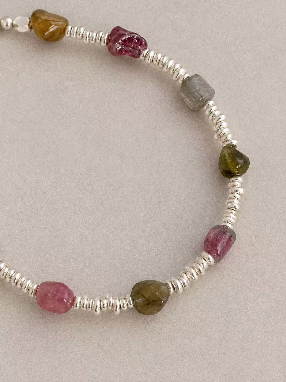 Close-up of irregular natural tourmaline beads and polished sterling silver disc spacers on the Bonbon bracelet.