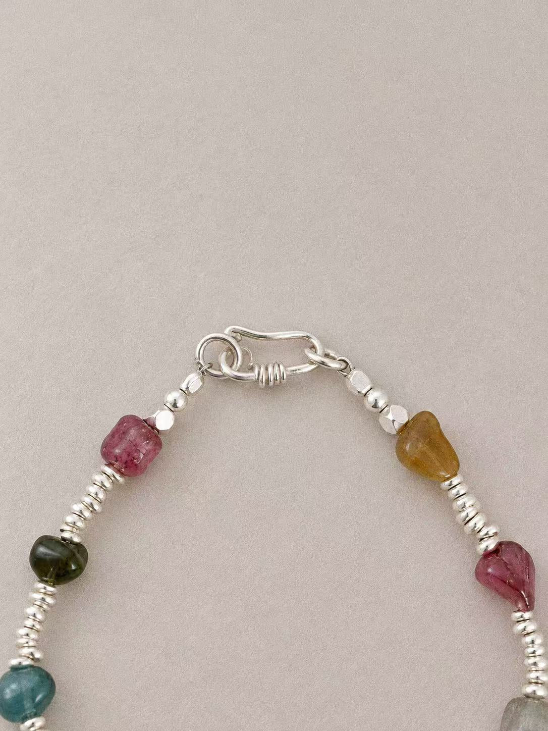 Hook-and-ring clasp on the Bonbon bracelet, with silver beads and natural tourmaline near the fastening.