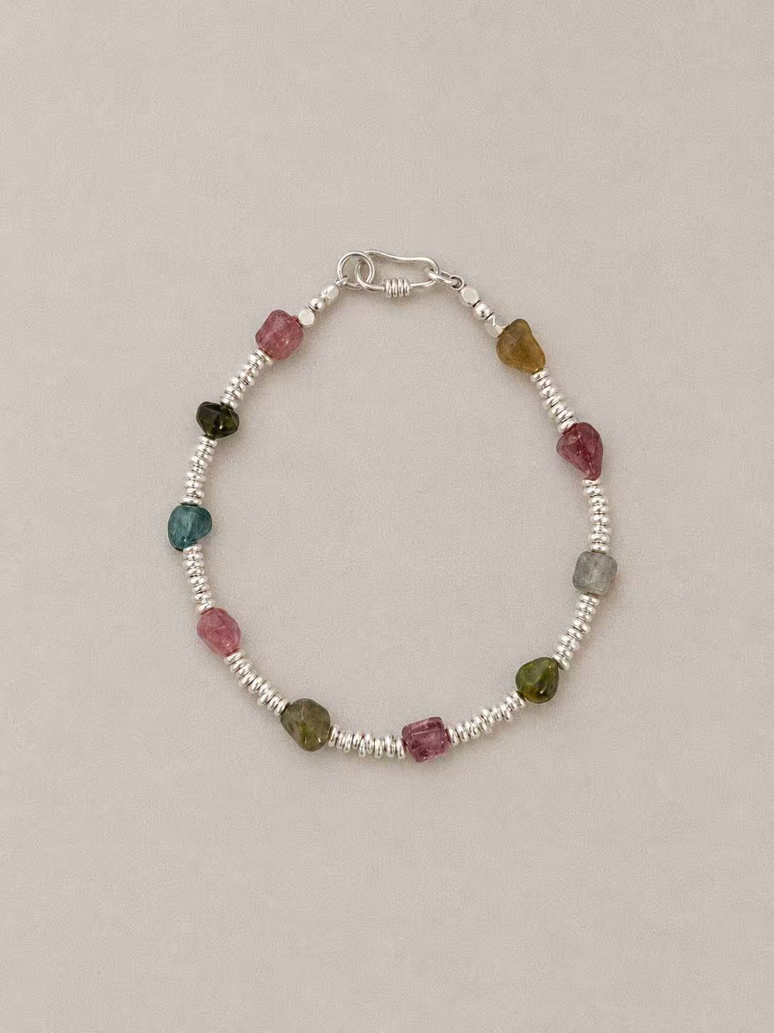 Bonbon natural tourmaline bracelet with multicolour gemstone beads, irregular sterling silver disc spacers and a hook clasp.