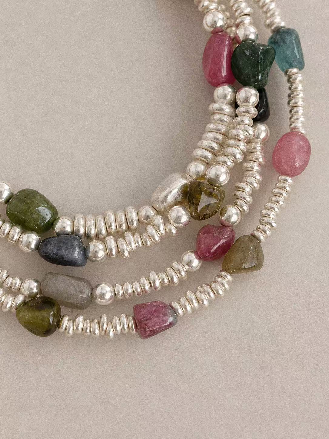 Bonbon tourmaline bracelet shown alongside coordinating jewellery, highlighting the natural stones and irregular silver details.