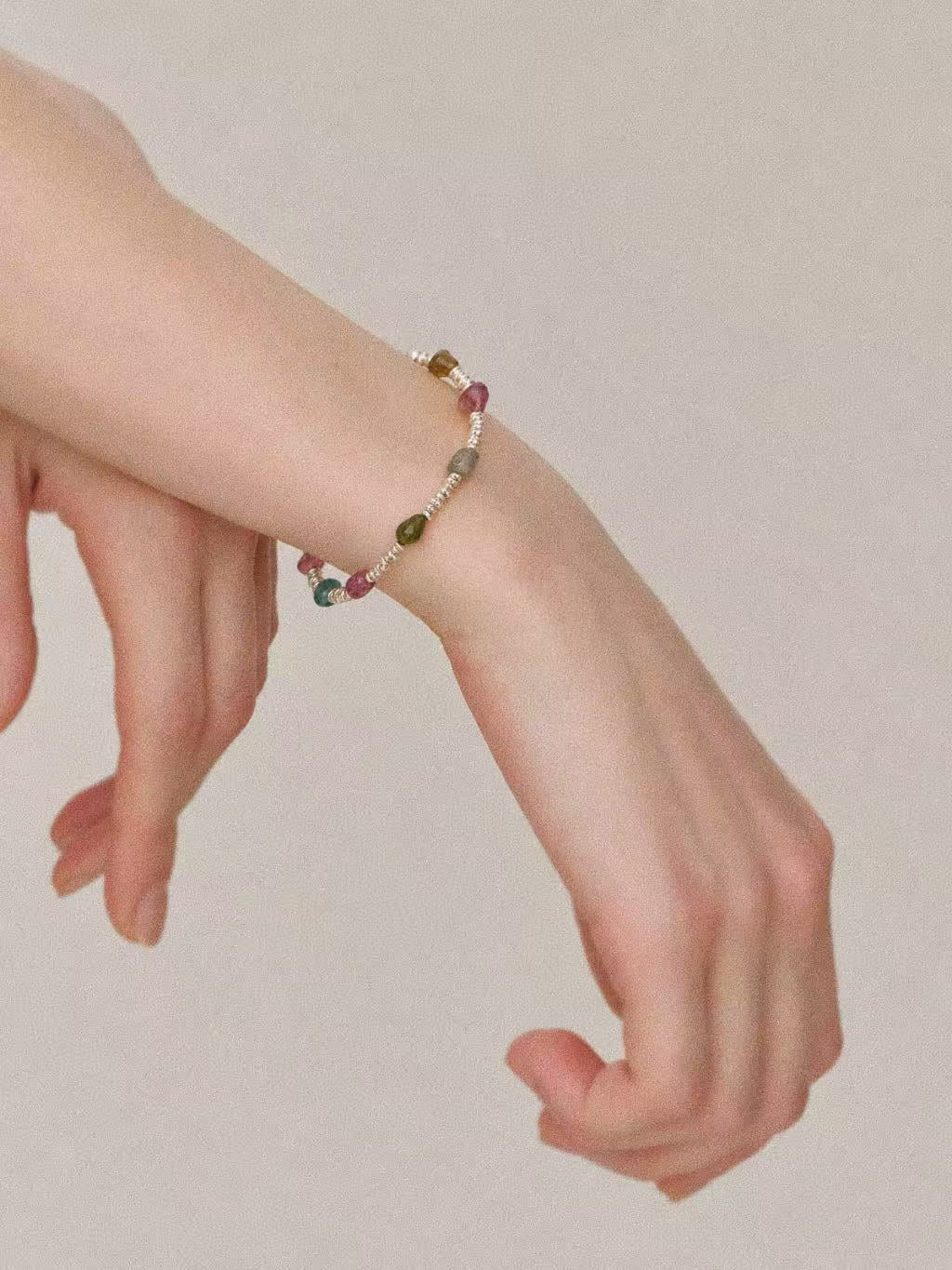 Bonbon tourmaline and sterling silver bracelet worn on a wrist, showing the delicate beaded design.
