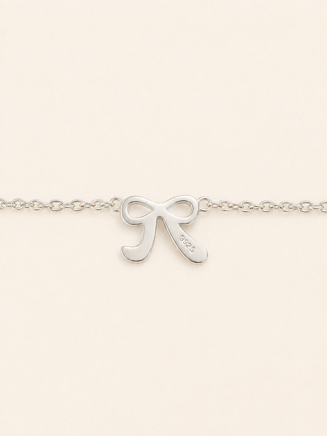 Back of the Ballet bow charm showing its 925 stamp, solid sterling silver through and through.