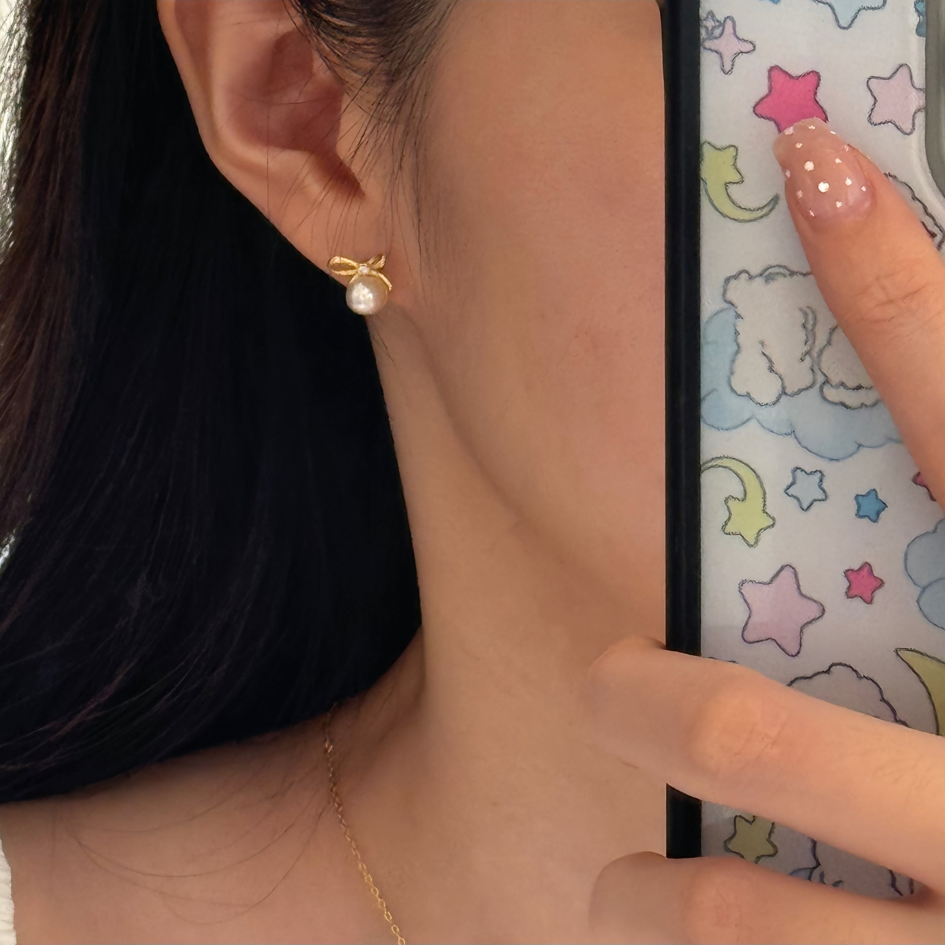 Gold bow ribbon pearl studs with tiny accent stone at knot, hypoallergenic posts