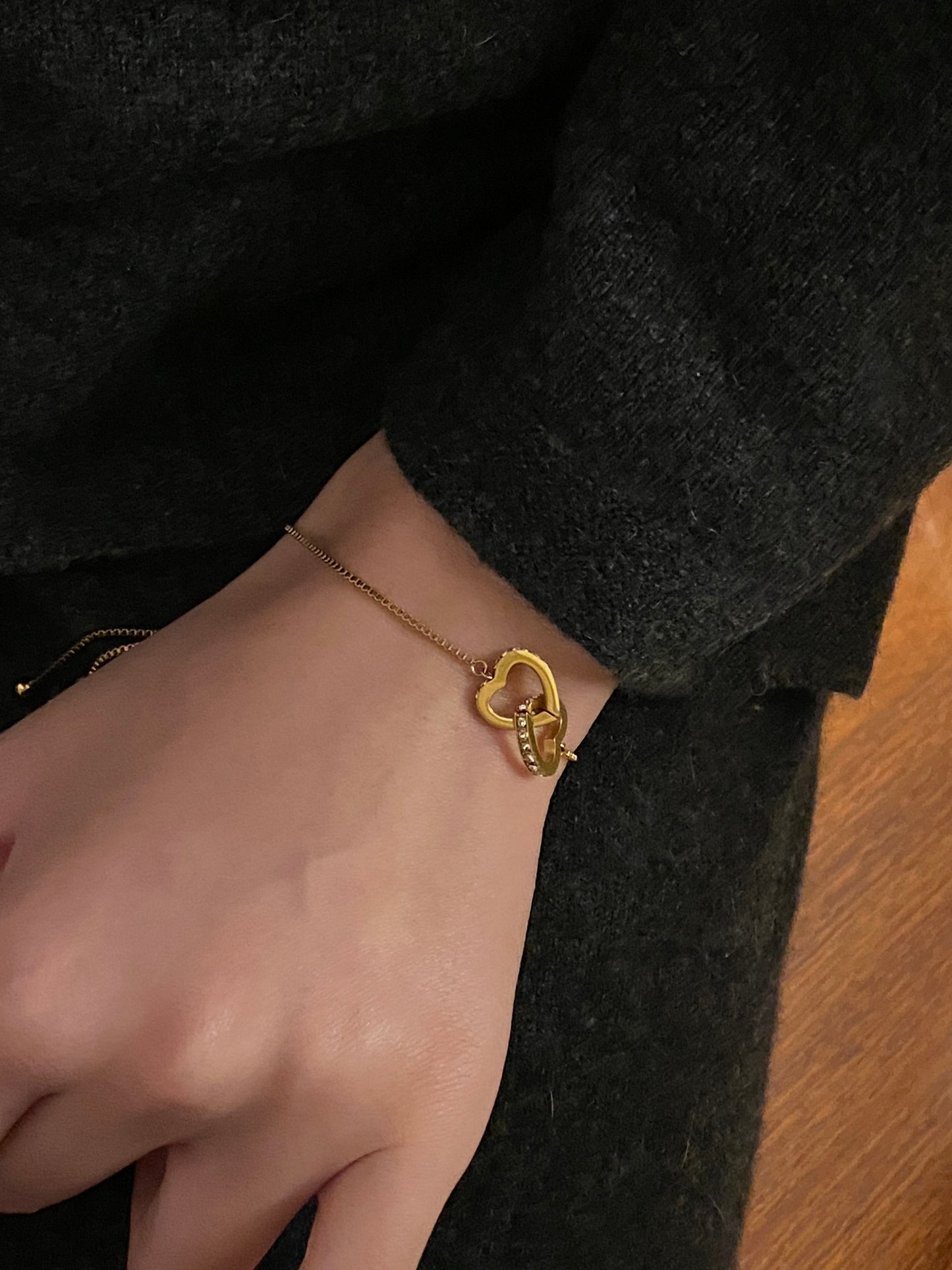 Model styling the Connected Hearts bracelet, a waterproof stainless steel friendship bracelet for best friends.