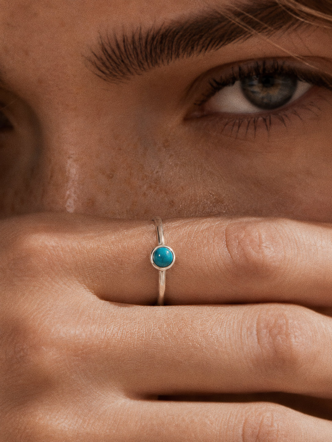 Cove handmade Sleeping Beauty turquoise ring in 925 sterling silver, worn on the hand with a natural 5 mm stone.