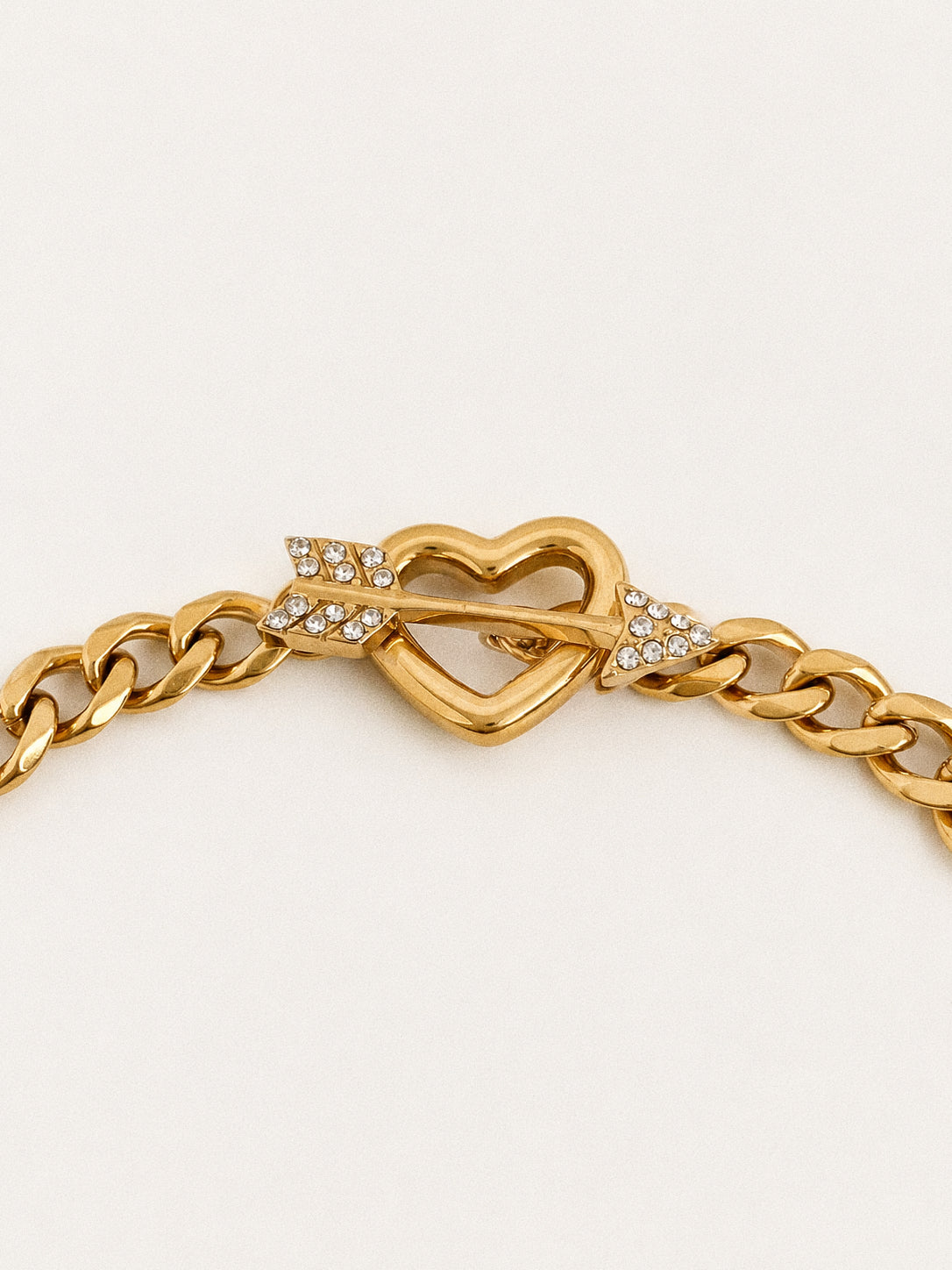 Close up of the heart toggle clasp with a crystal set arrow bar sliding through the open heart