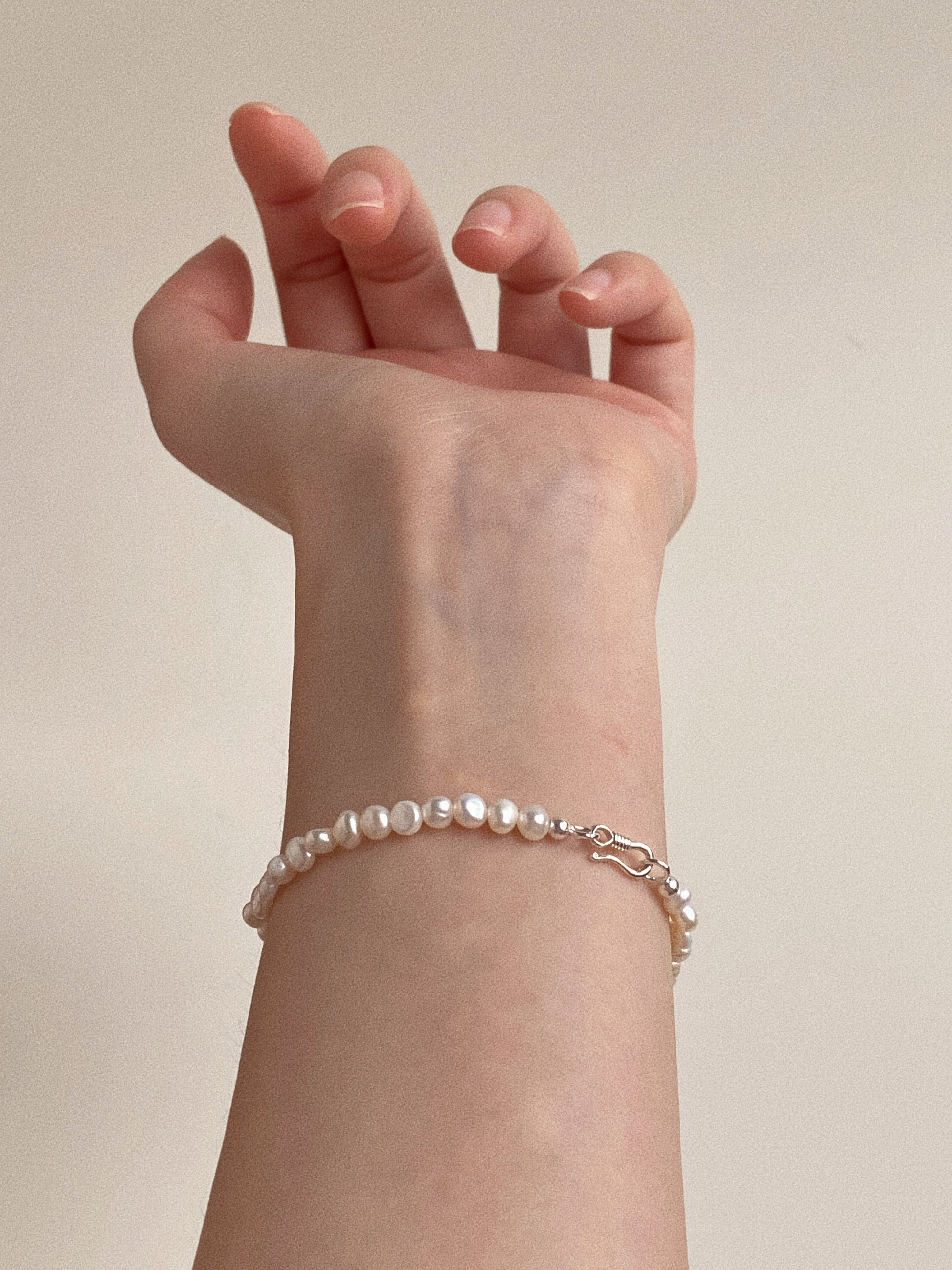 Model wearing the Petite Baroque Pearl Bracelet, showcasing the delicate 4-5mm size suitable for small wrists.