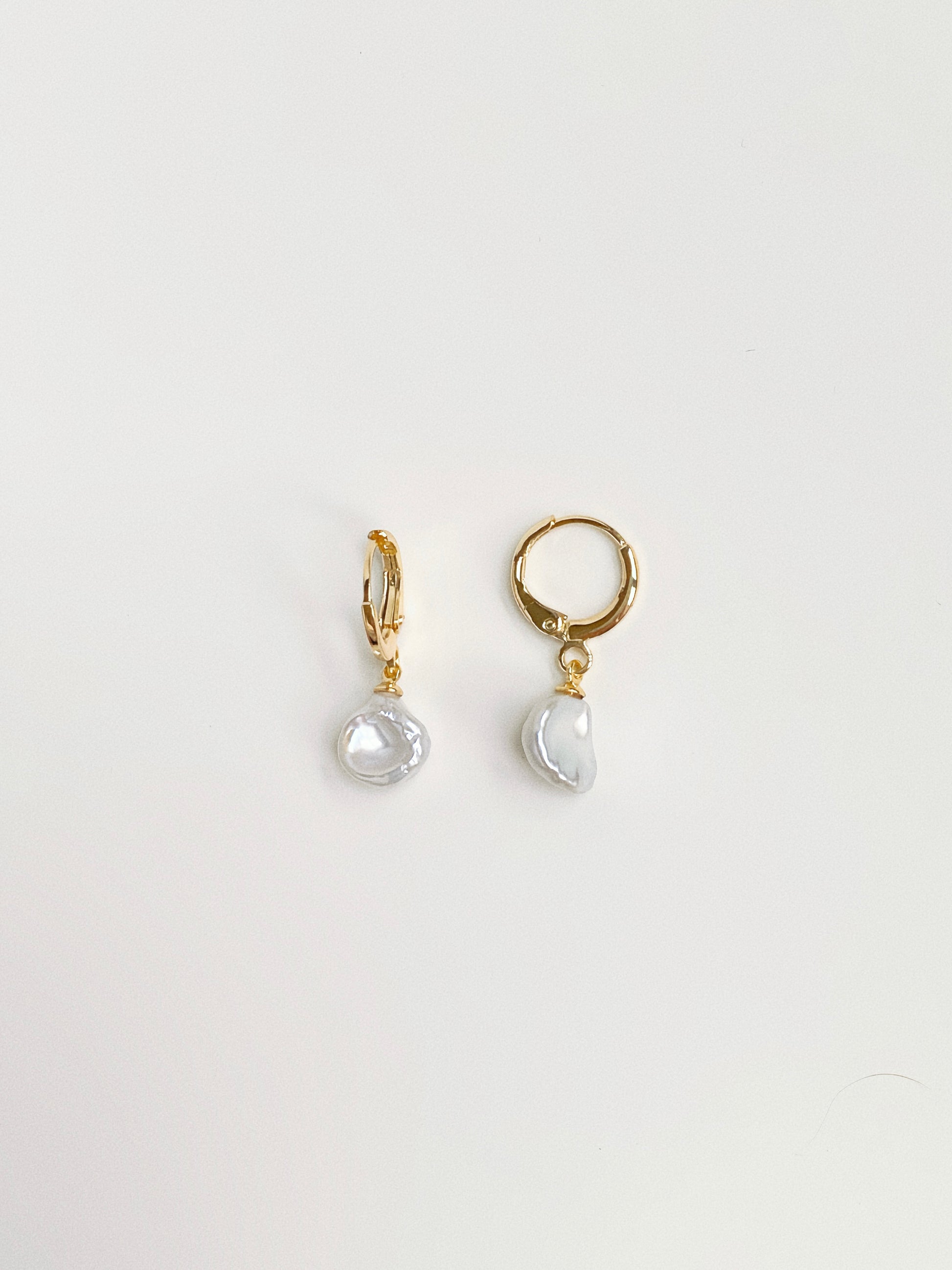 Dainty 10mm gold huggie hoop earrings with natural freshwater petal pearl drops