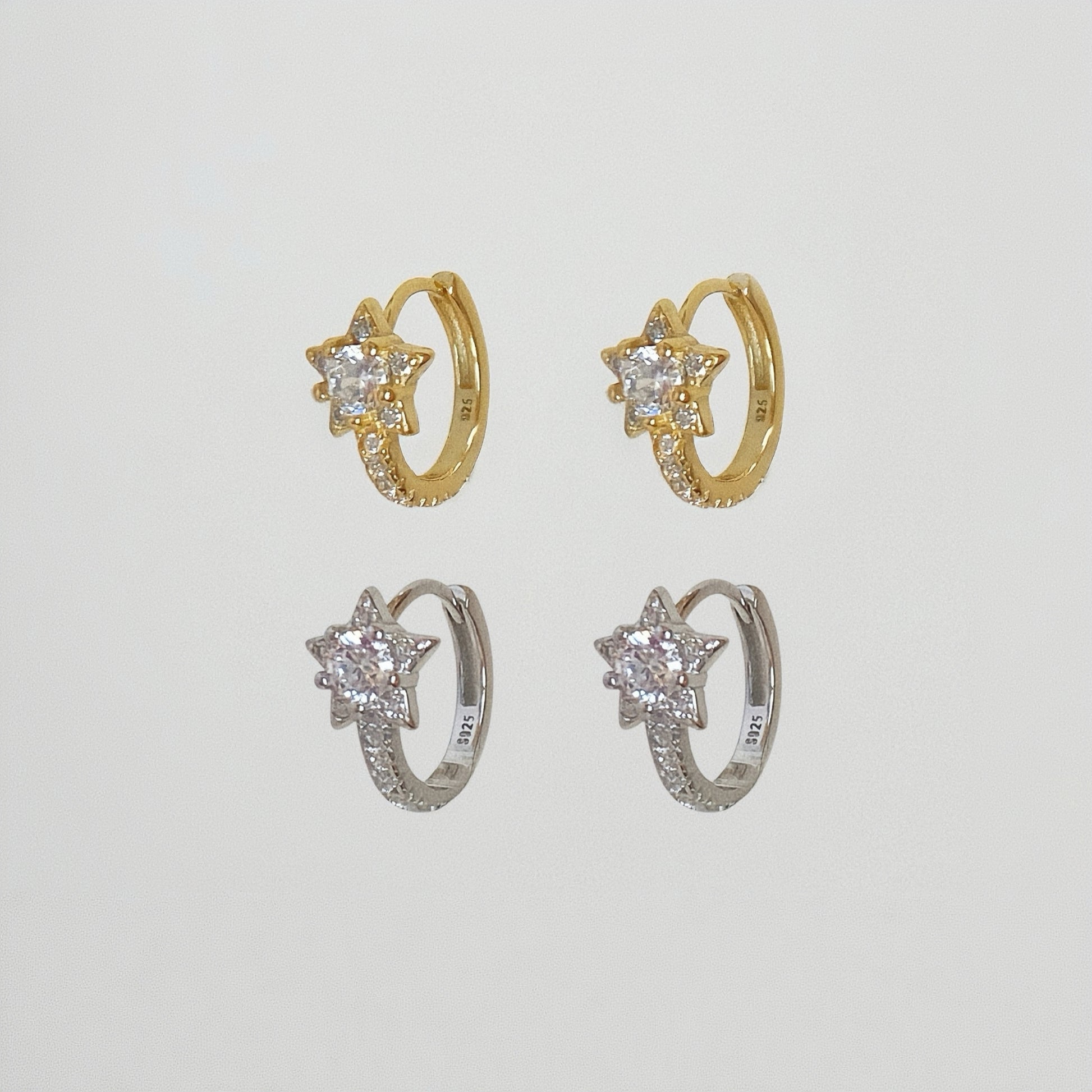 Comparison of 18k Gold Vermeil and 925 Sterling Silver star huggie earrings with pave crystal details.