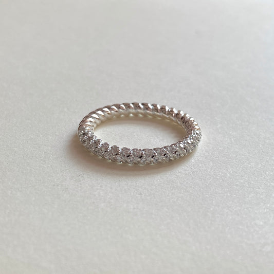 Macro of the slim rope-texture shank with continuous pavé stones across the top, on a white background.