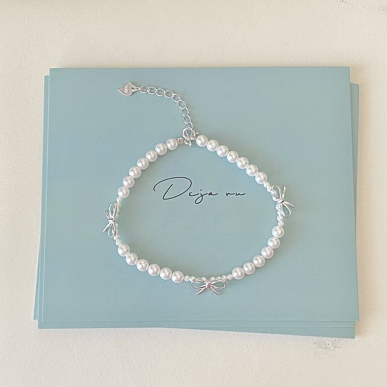 Dainty bow pearl bracelet close-up for bridesmaid gift