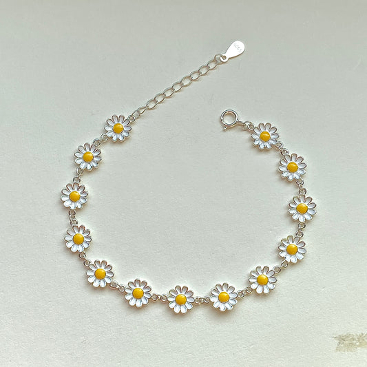 Sterling silver daisy enamel bracelet with extender, flat lay