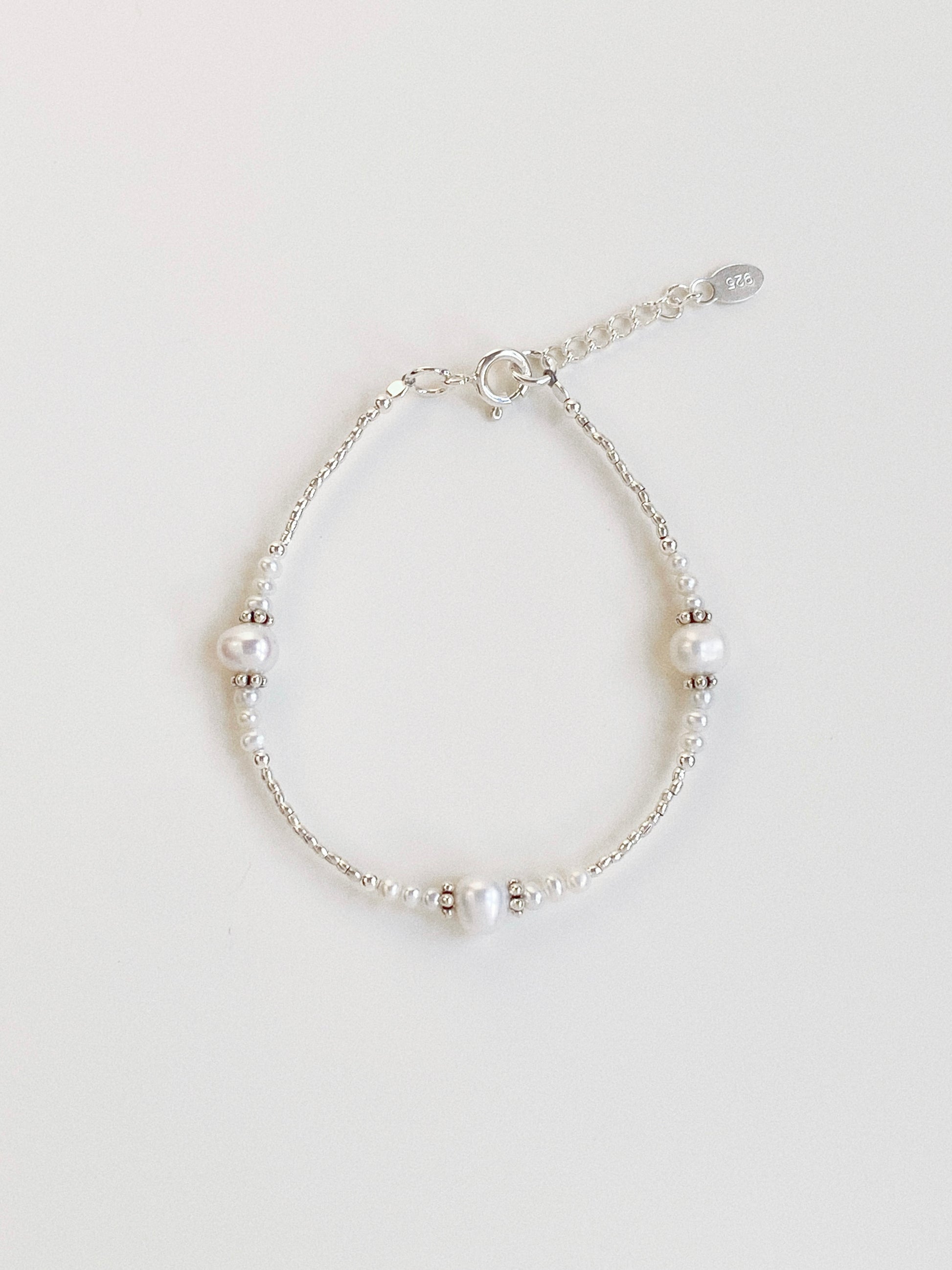 A dainty handmade bracelet featuring high-lustre freshwater pearls and 925 sterling silver beads from Deja vu Jewellery.