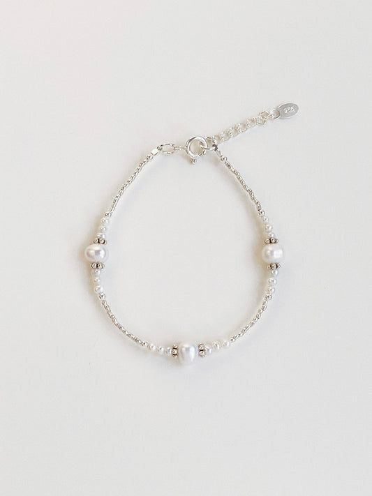 A dainty handmade bracelet featuring high-lustre freshwater pearls and 925 sterling silver beads from Deja vu Jewellery.