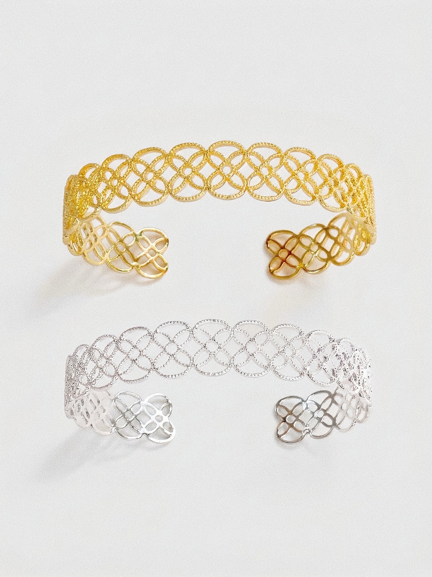 A comparison view of the Arabesque Petal Lace Cuff in both vintage gold and sterling silver plating.