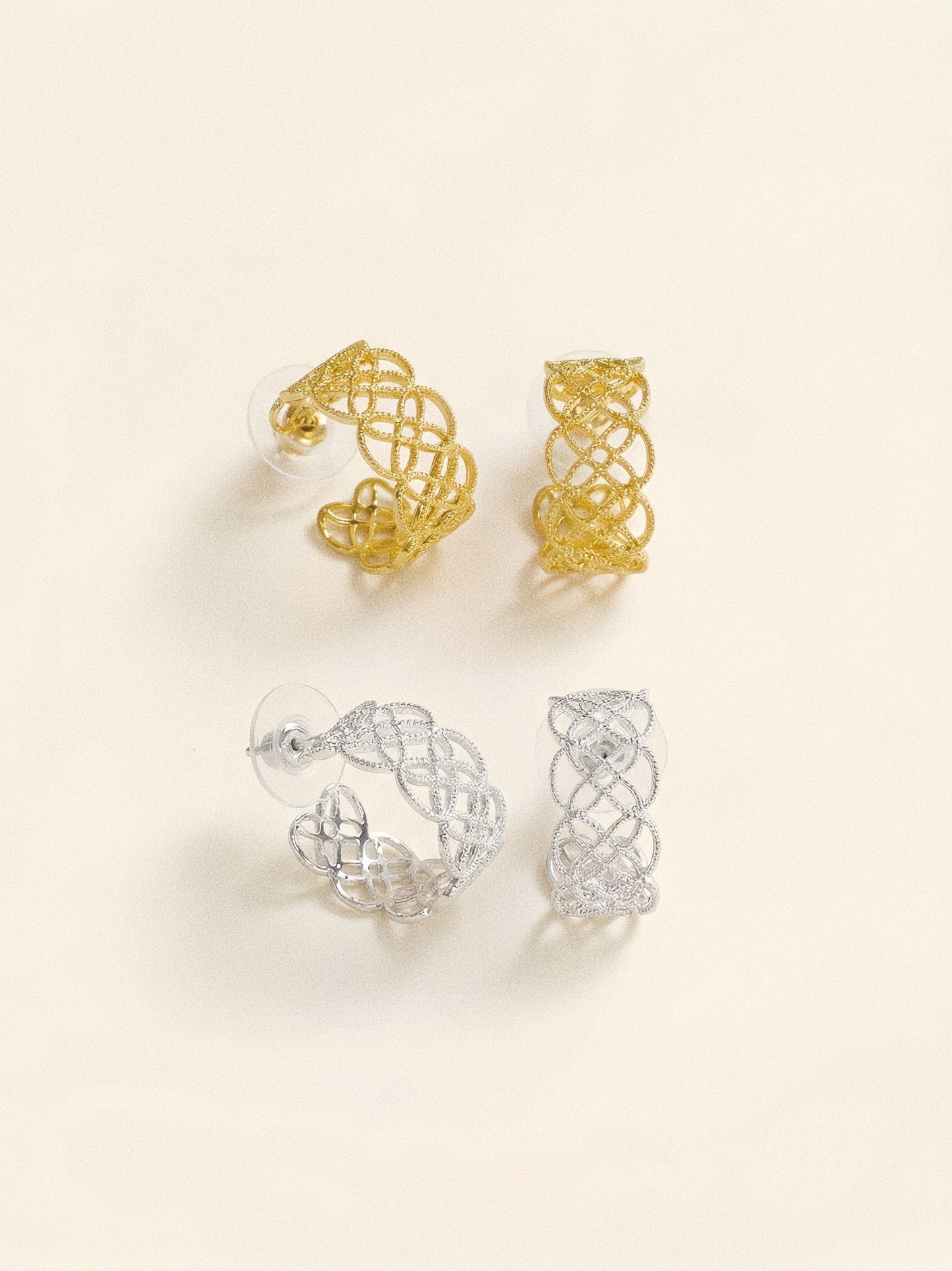 A comparison of the Arabesque Petal Lace Hoops in both 18k gold and sterling silver plating.