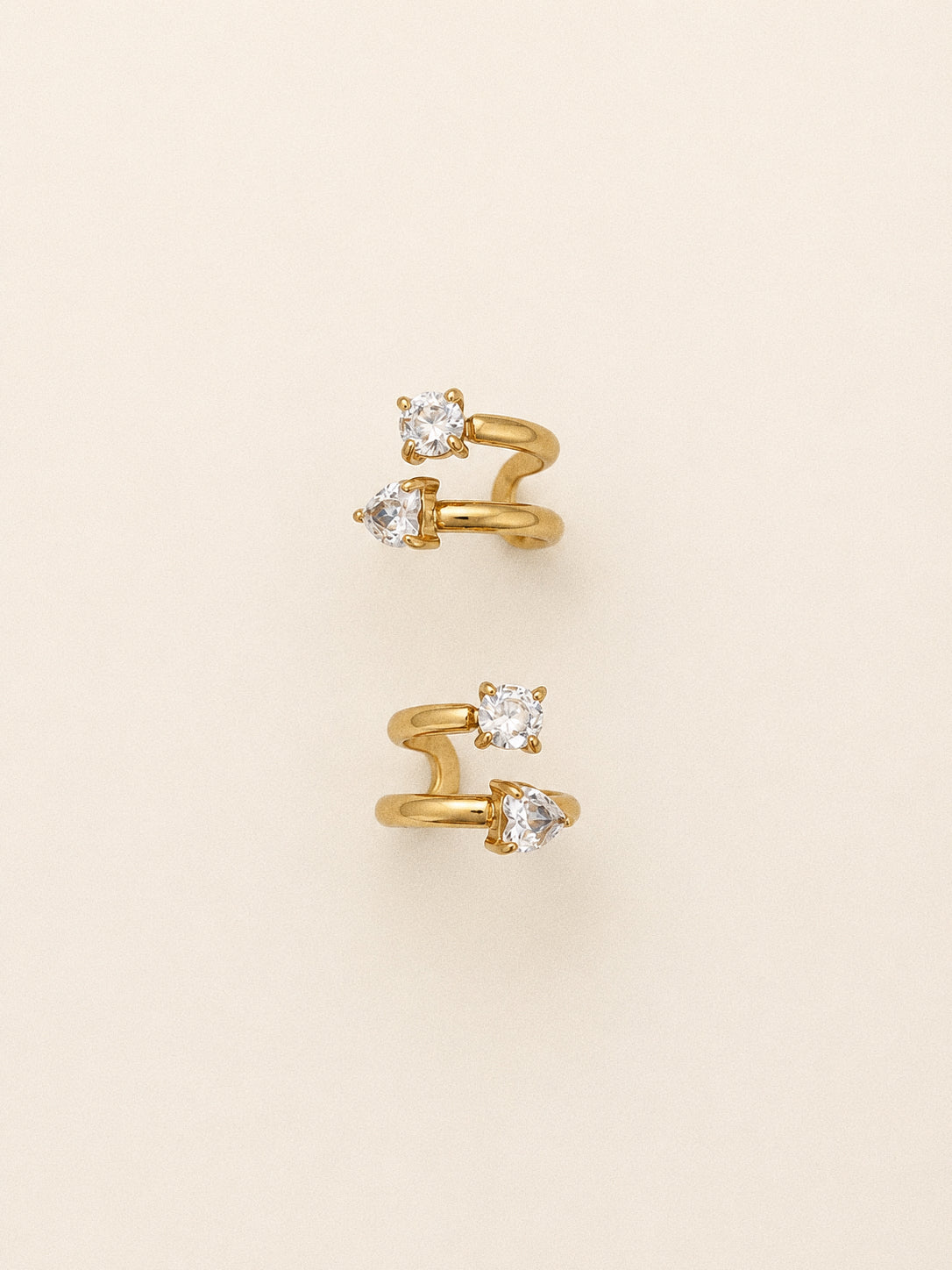 Duet double ear cuff with a round cz on the upper coil and a heart cut stone below in 18k gold