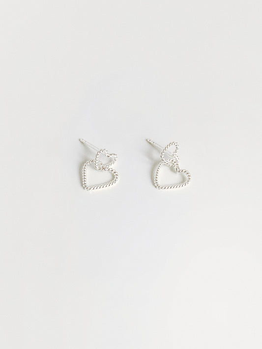 Dainty double heart stud earrings in 925 sterling silver with twisted rope texture flat lay by Deja vu Jewellery