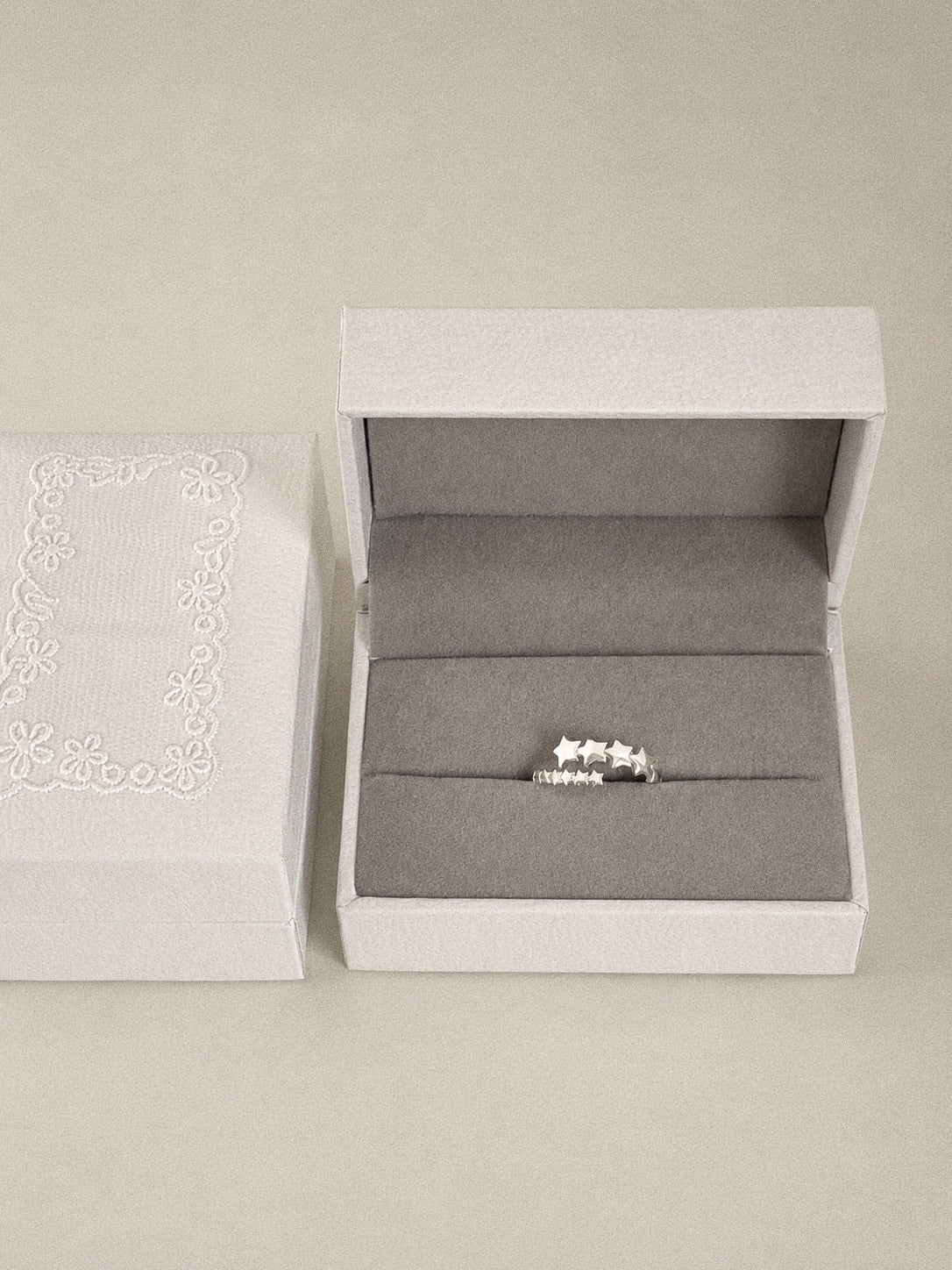 Drift sterling silver multi star ring presented in a Deja vu Jewellery gift box with the star band facing forward.
