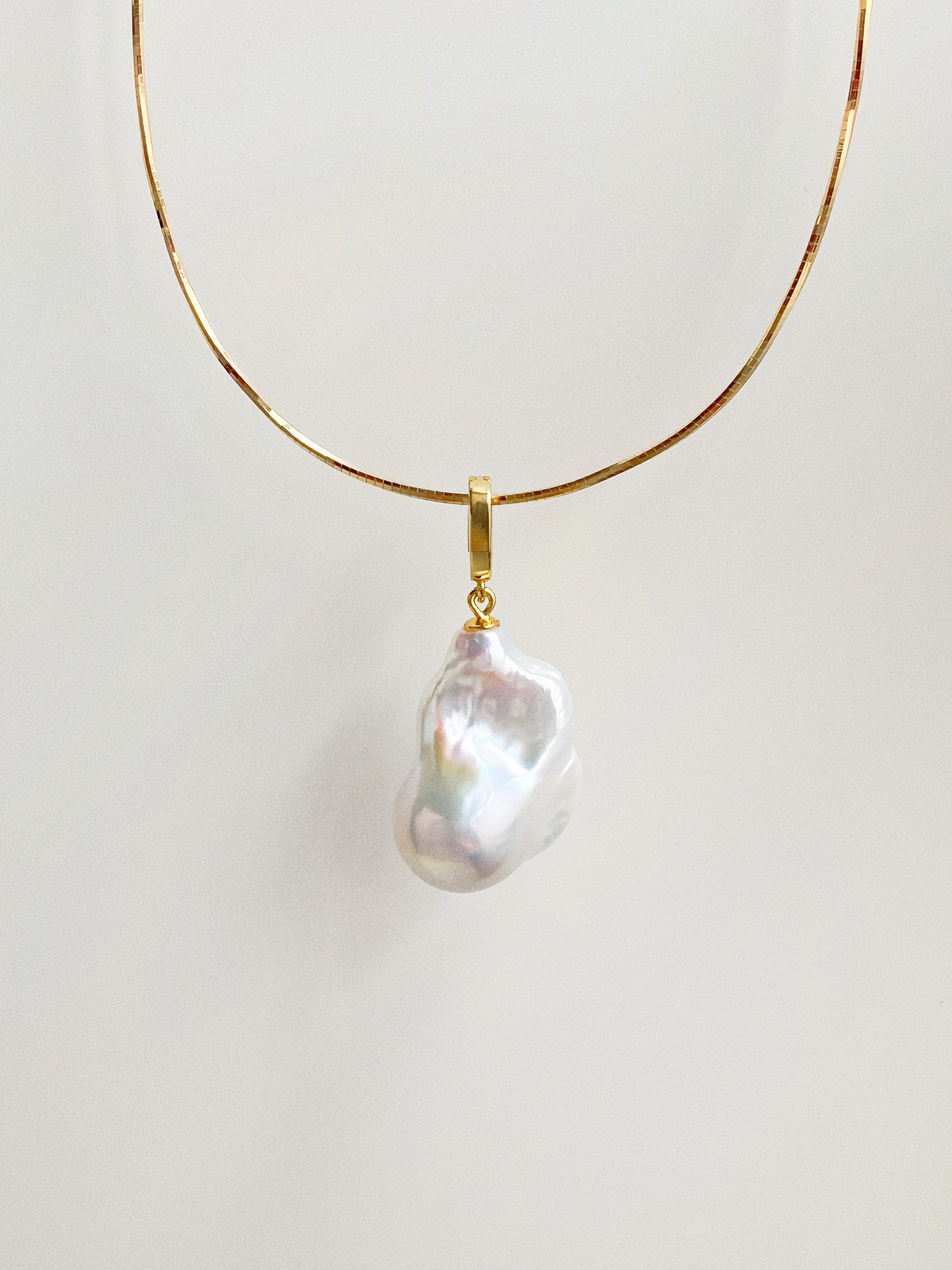 Ethereal natural baroque fishtail pearl pendant on gold-plated snake chain choker by Deja Vu Jewellery
