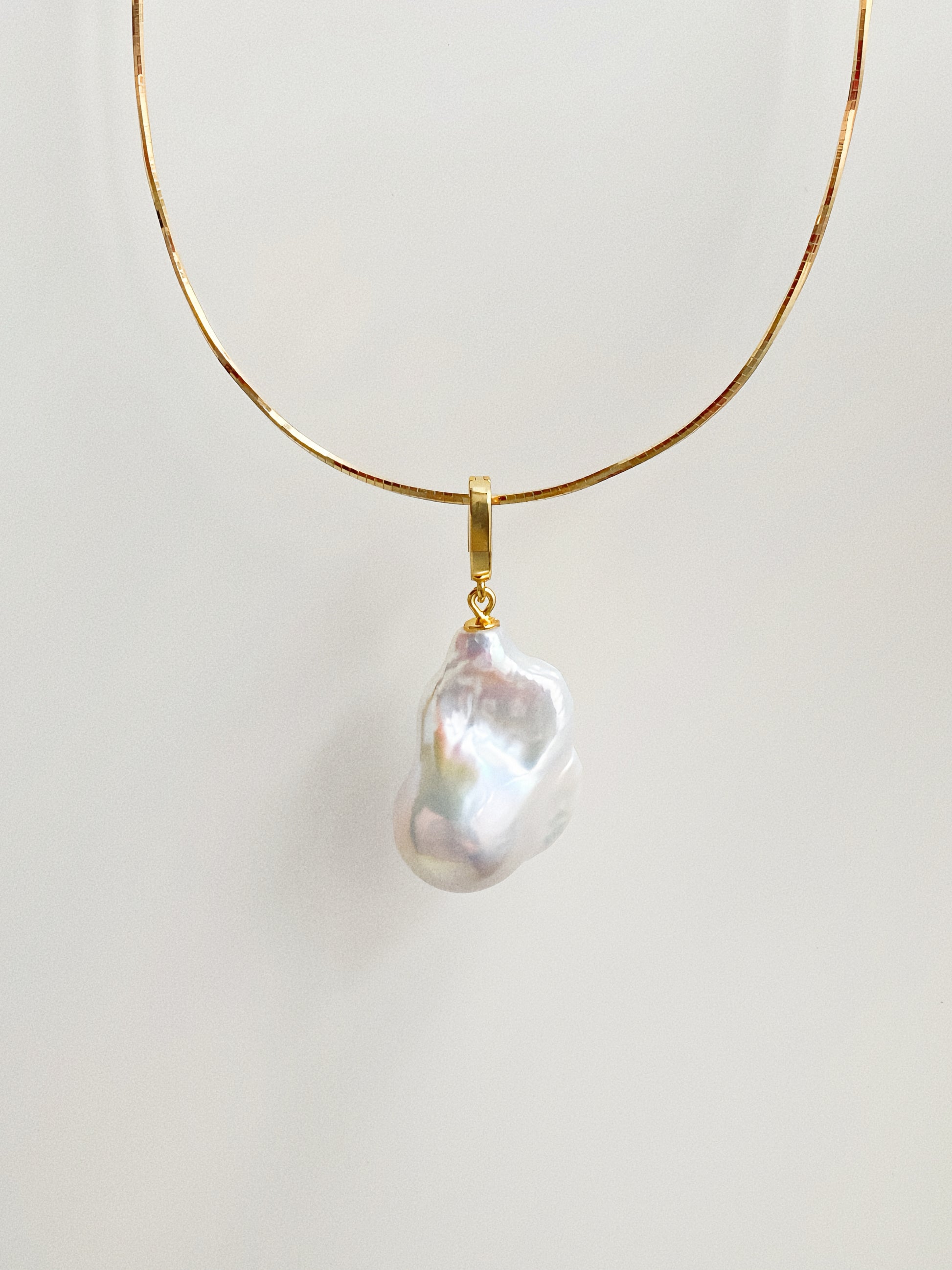 Ethereal natural baroque fishtail pearl pendant on gold-plated snake chain choker by Deja Vu Jewellery