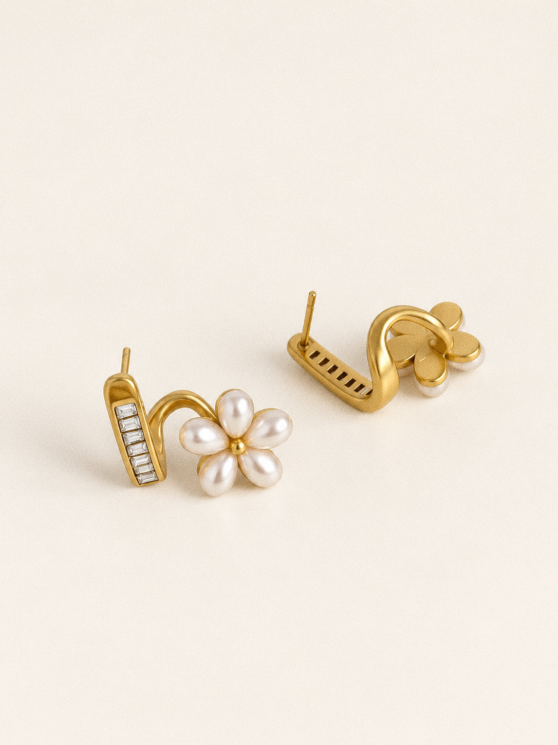 Front and back views of Fleurette flower stud earrings showing the posts, curved gold-tone connectors and faux pearl petals.