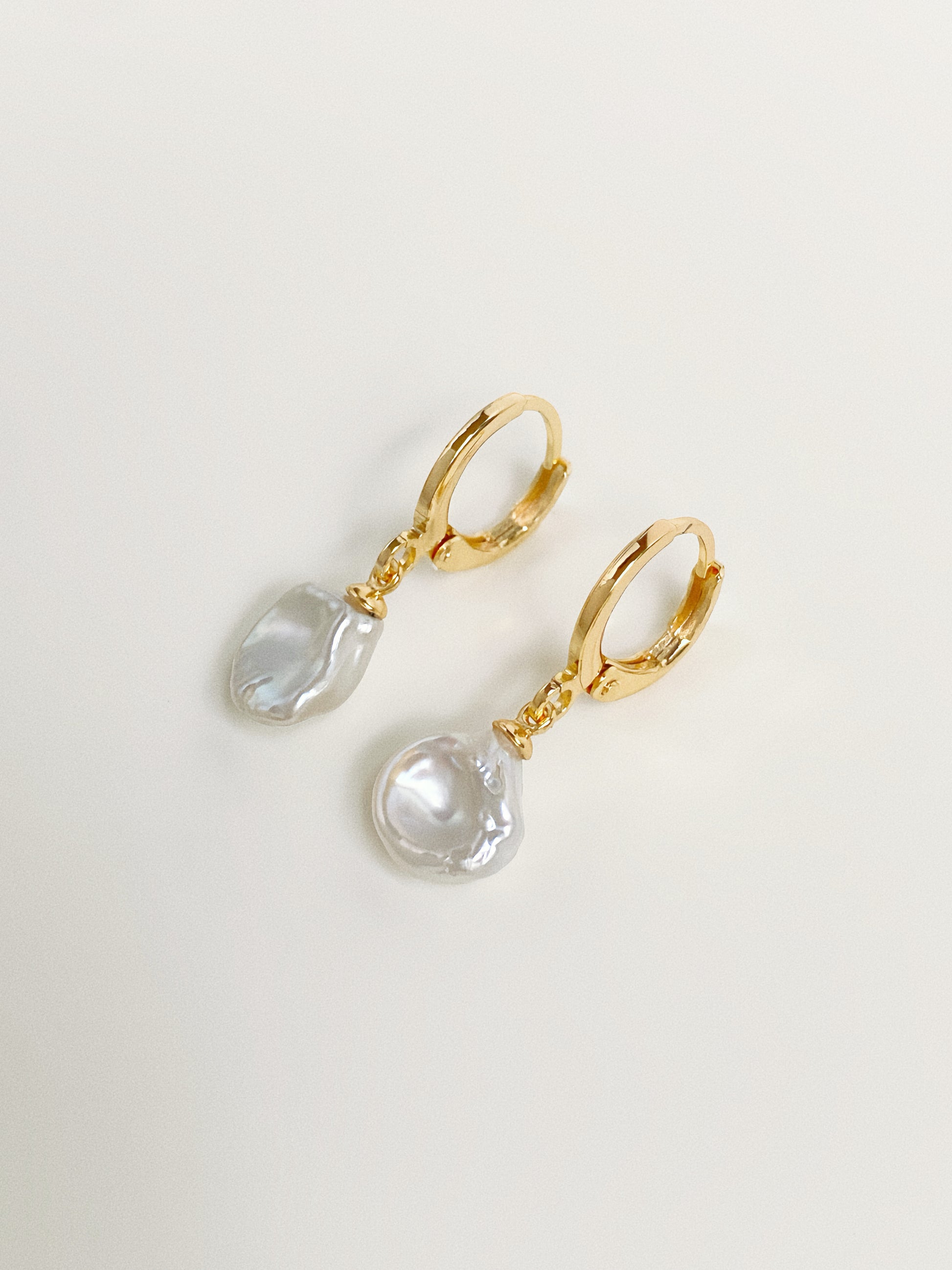 Close-up of natural freshwater petal pearl huggie hoop earrings showing organic pearl shape and lustre