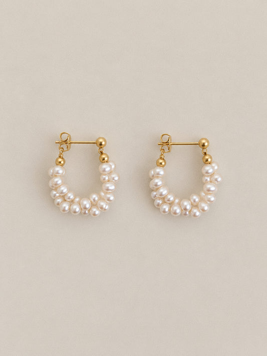 Pair of Garland freshwater pearl hoop earrings with twisted pearl strands, gold-tone ball studs and butterfly backs.