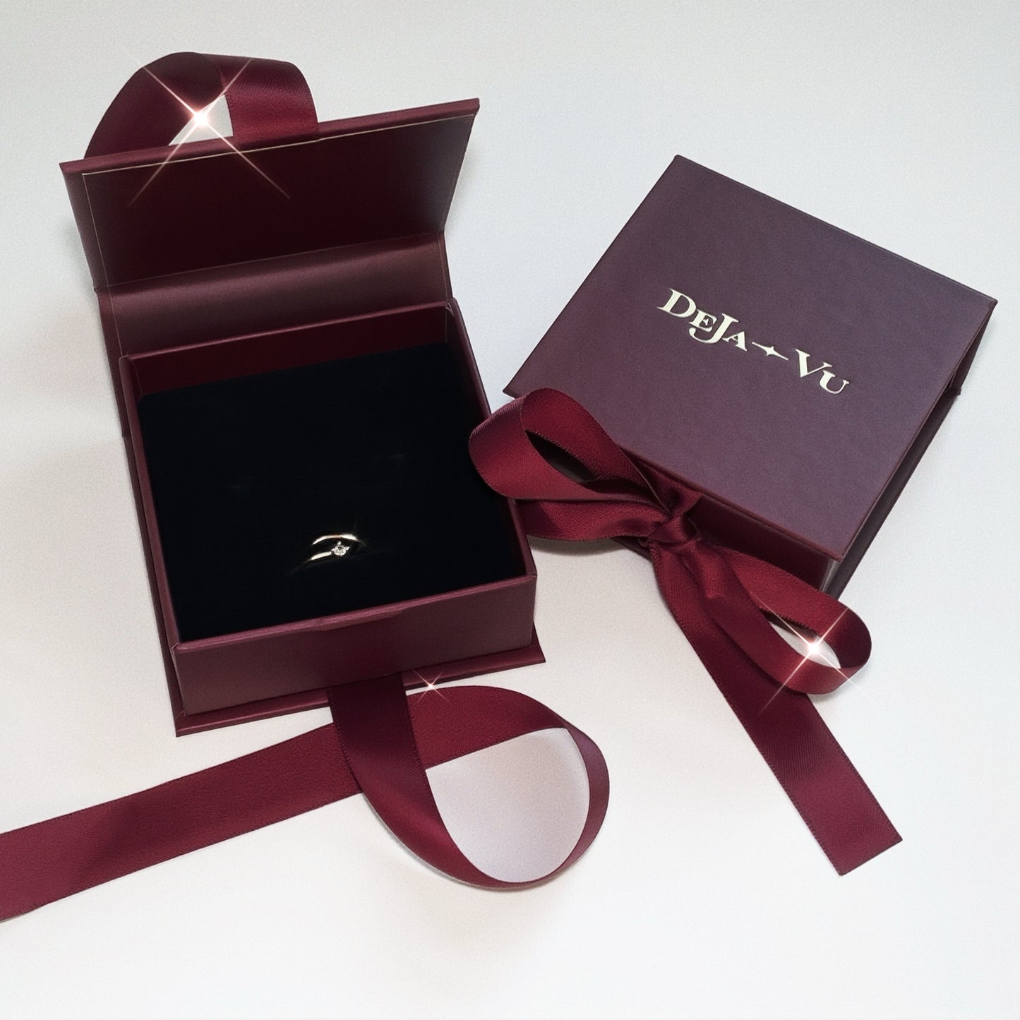 Deja vu Jewellery burgundy gift box with dainty open gold pinky ring inside on black velvet