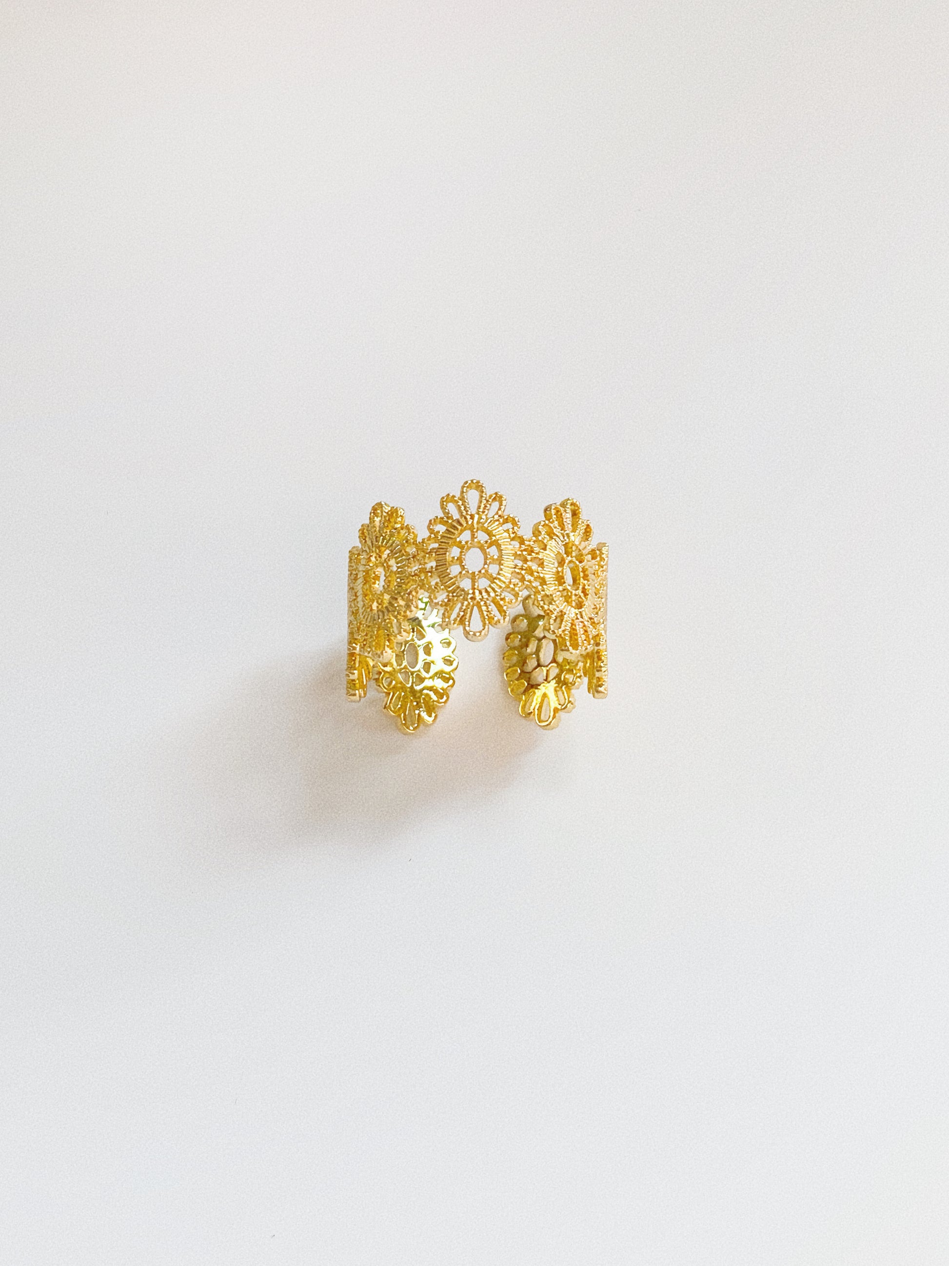 Gold vintage lace statement ring shown adjustable showing intricate floral lacework detail